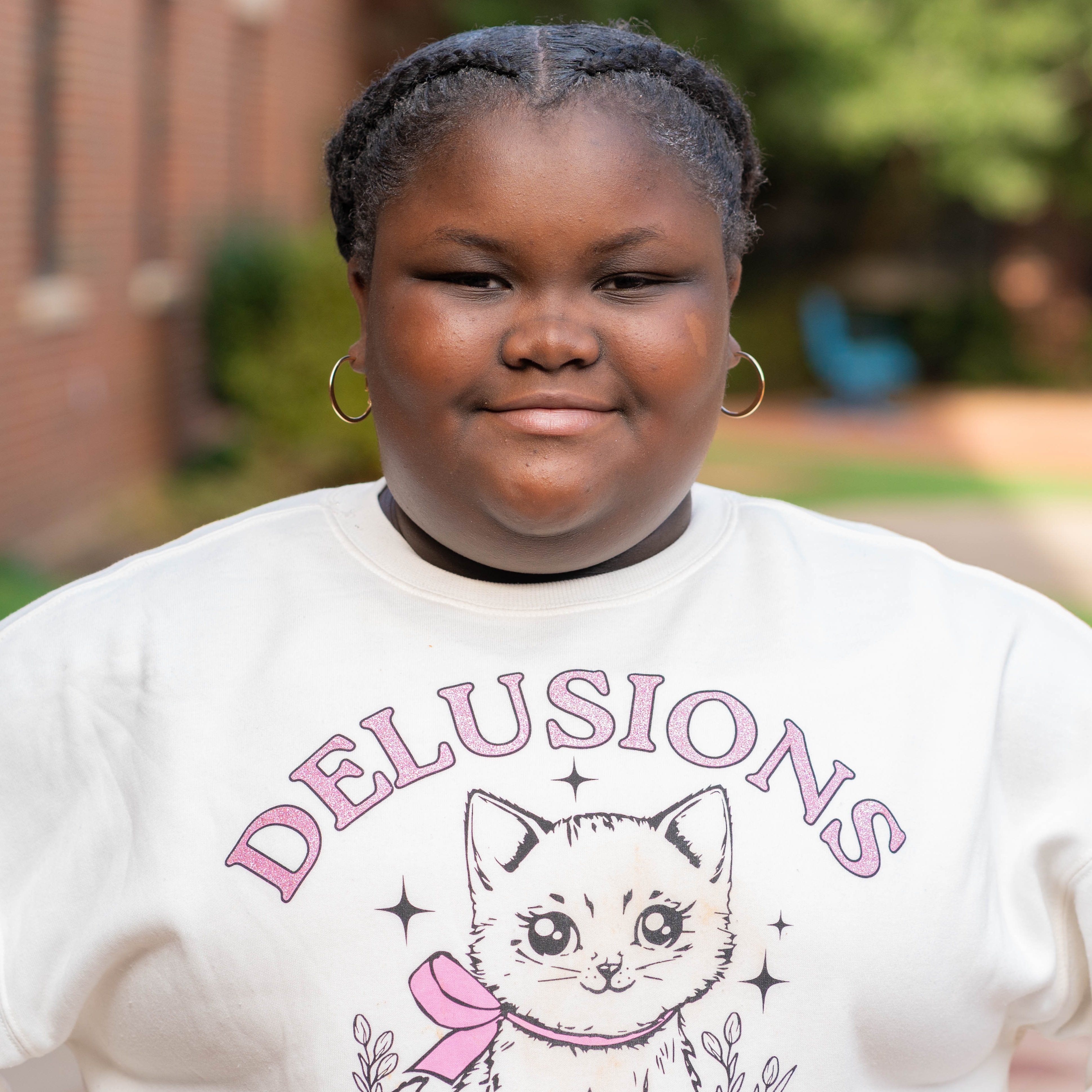 elementary age girl smiling with mouth closed