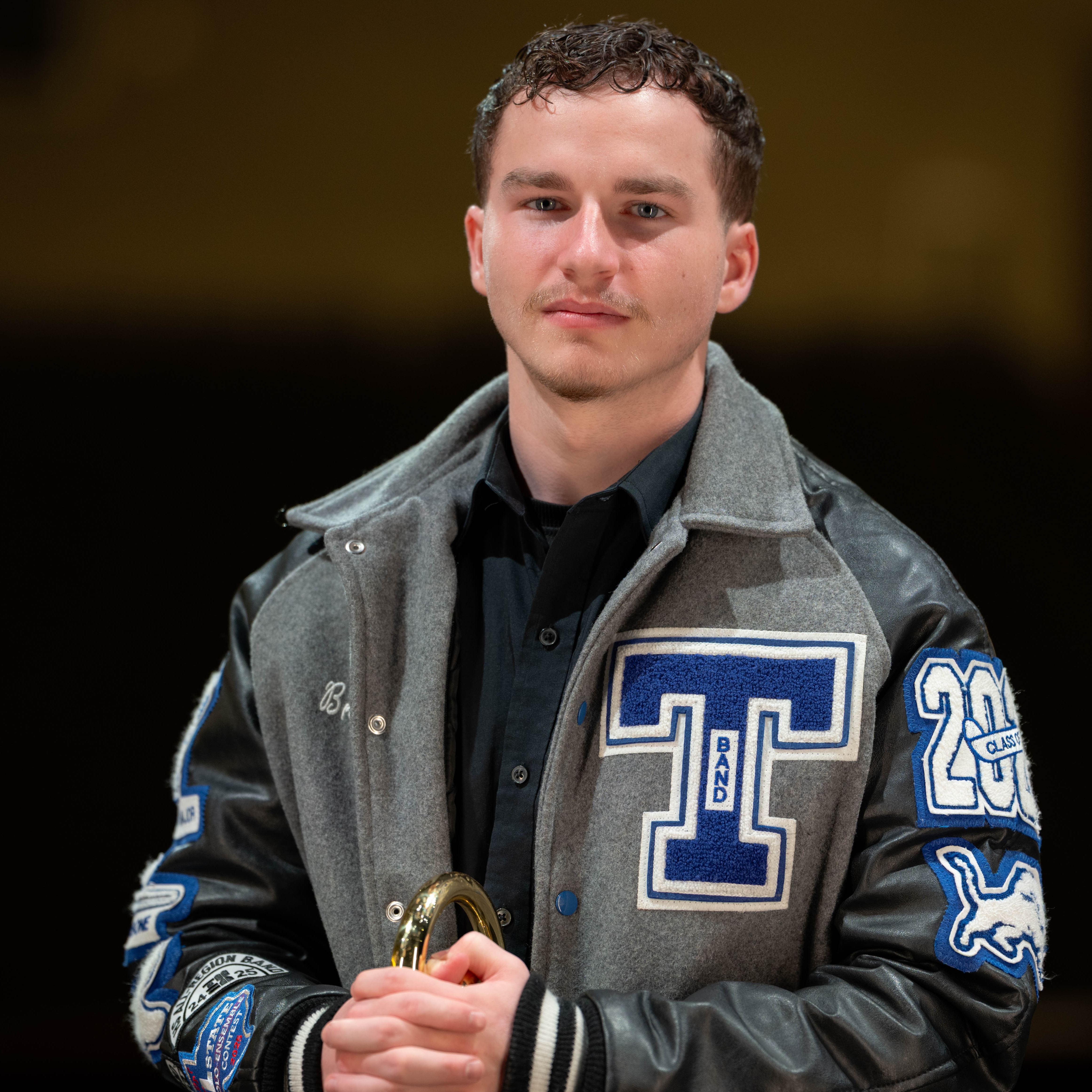 teen boy wearing his Tyler High letter jacket