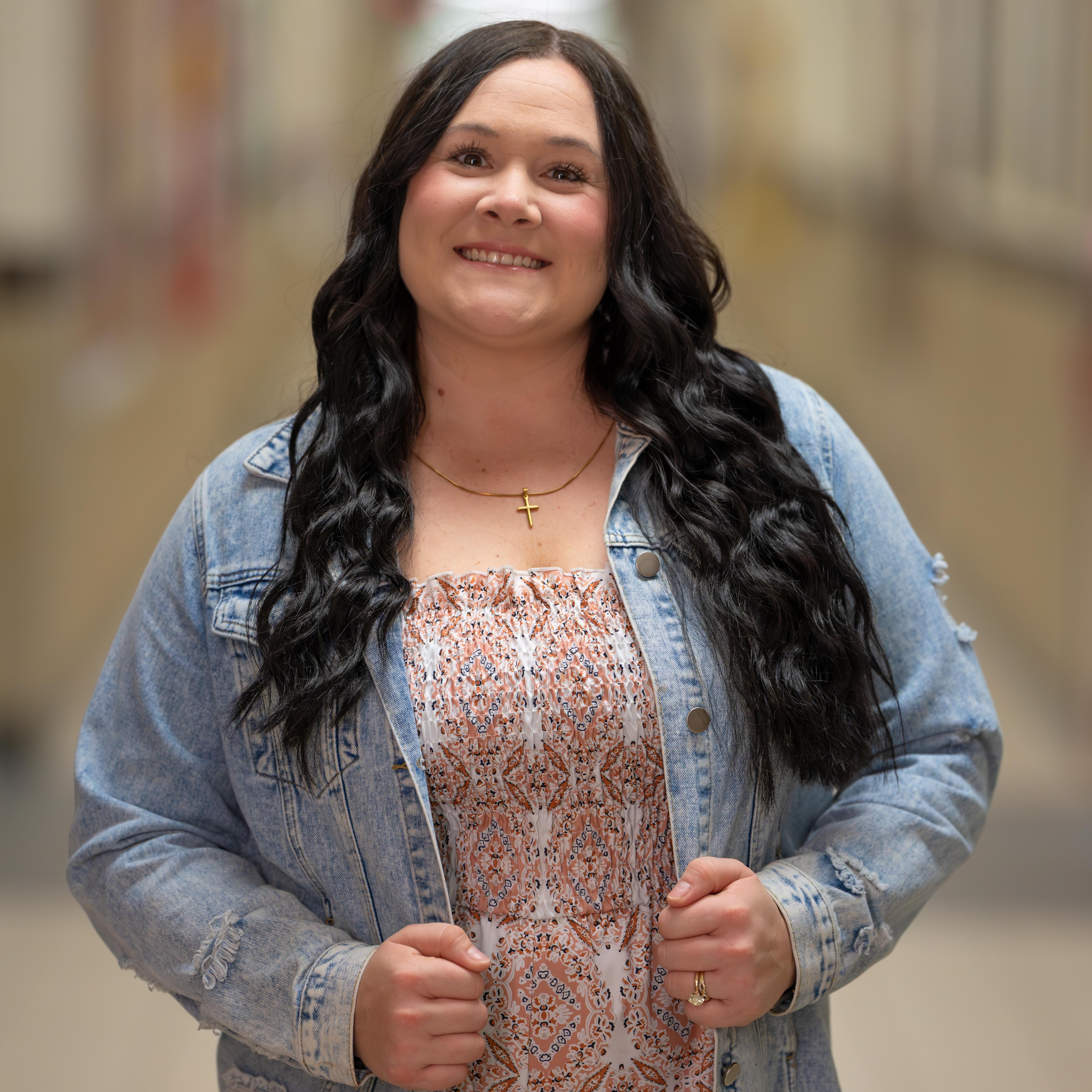 woman with long dark hair wearing a jean jacket