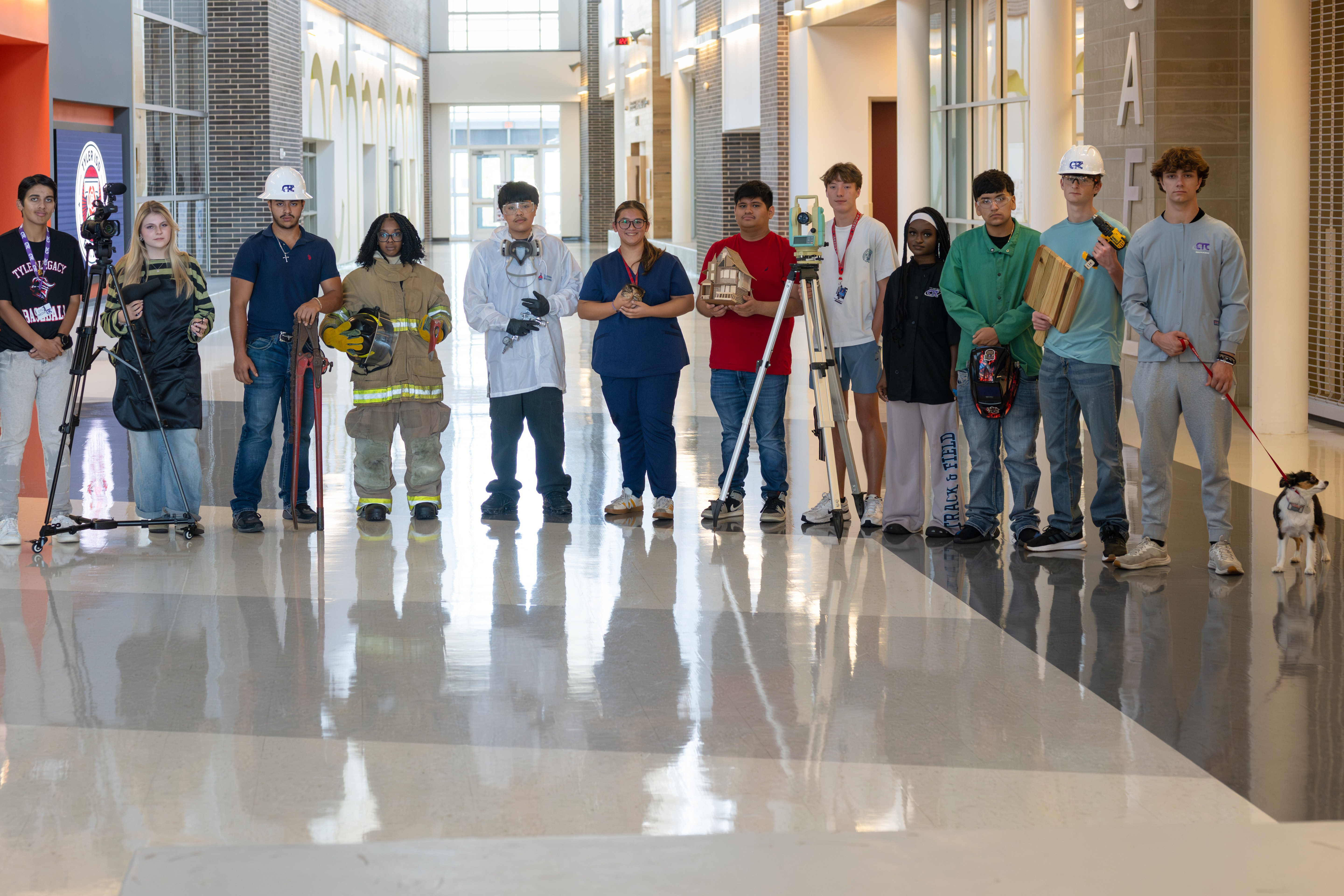 high school students wearing firefighter, doctor, welder, construction, cosmetologist outfits