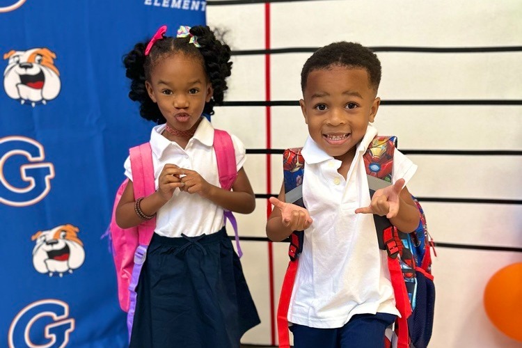 two pre-k kids with backpacks on