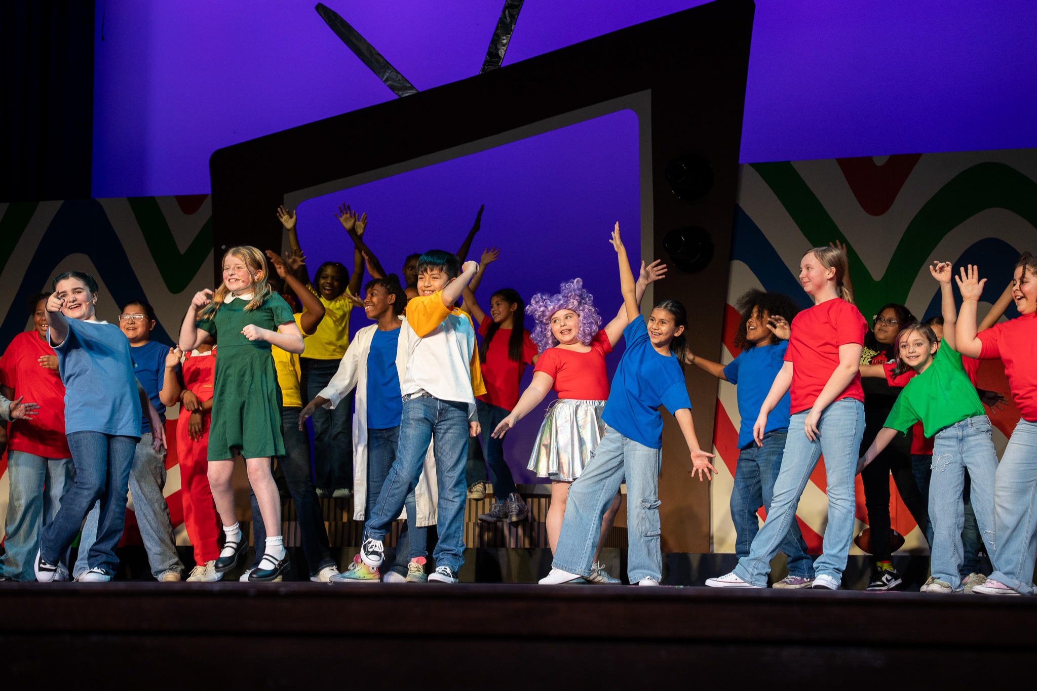 students in costumes performing on stage