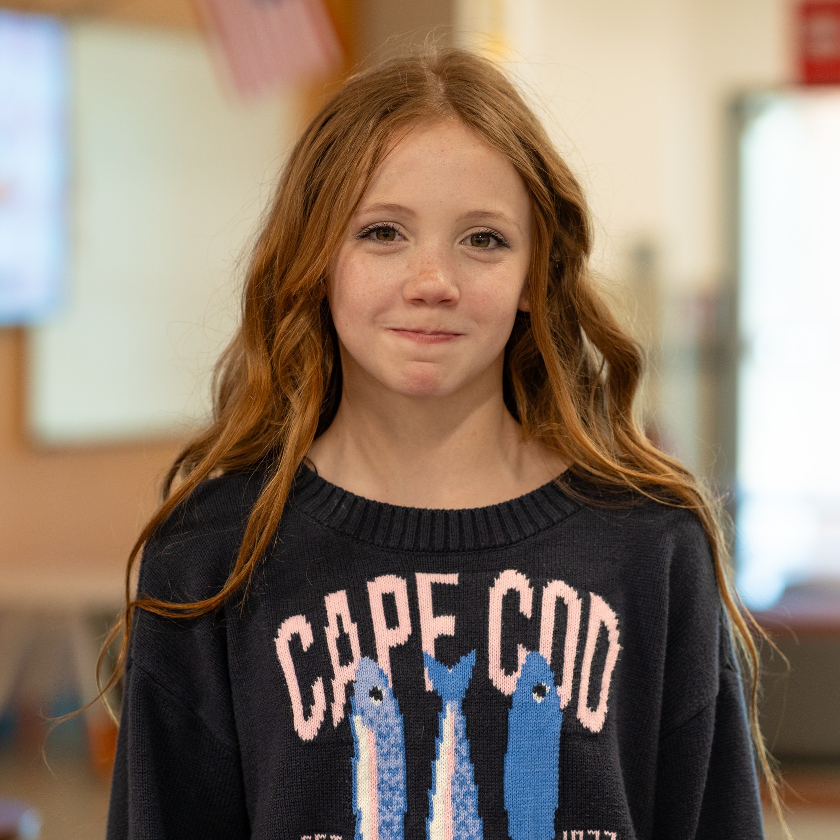 middle school girl with long red hair in classroom