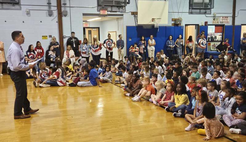 To commemorate 9/11, students at Belmont Elementary in front of the remembrance flag. Students and staff at DeLuca Elementary also participated in a 9/11 remembrance ceremony.