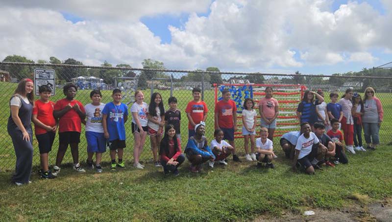 To commemorate 9/11, students at Belmont Elementary in front of the remembrance flag. Students and staff at DeLuca Elementary also participated in a 9/11 remembrance ceremony.