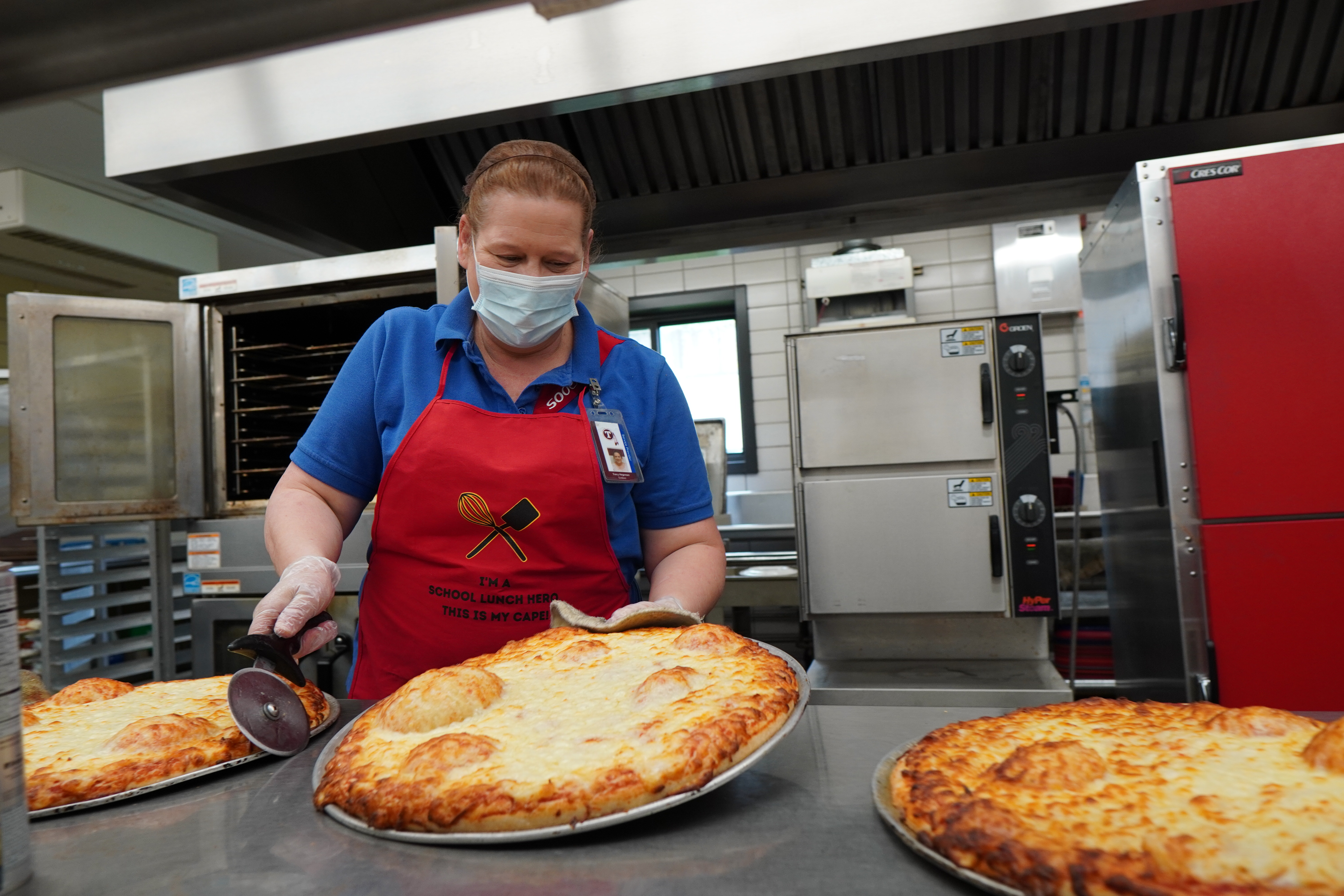 Pizza comes out of the oven at Tonawanda Middle School's kitchen.