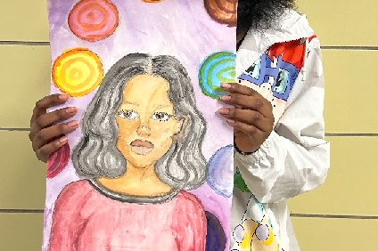 Girl holding artwork