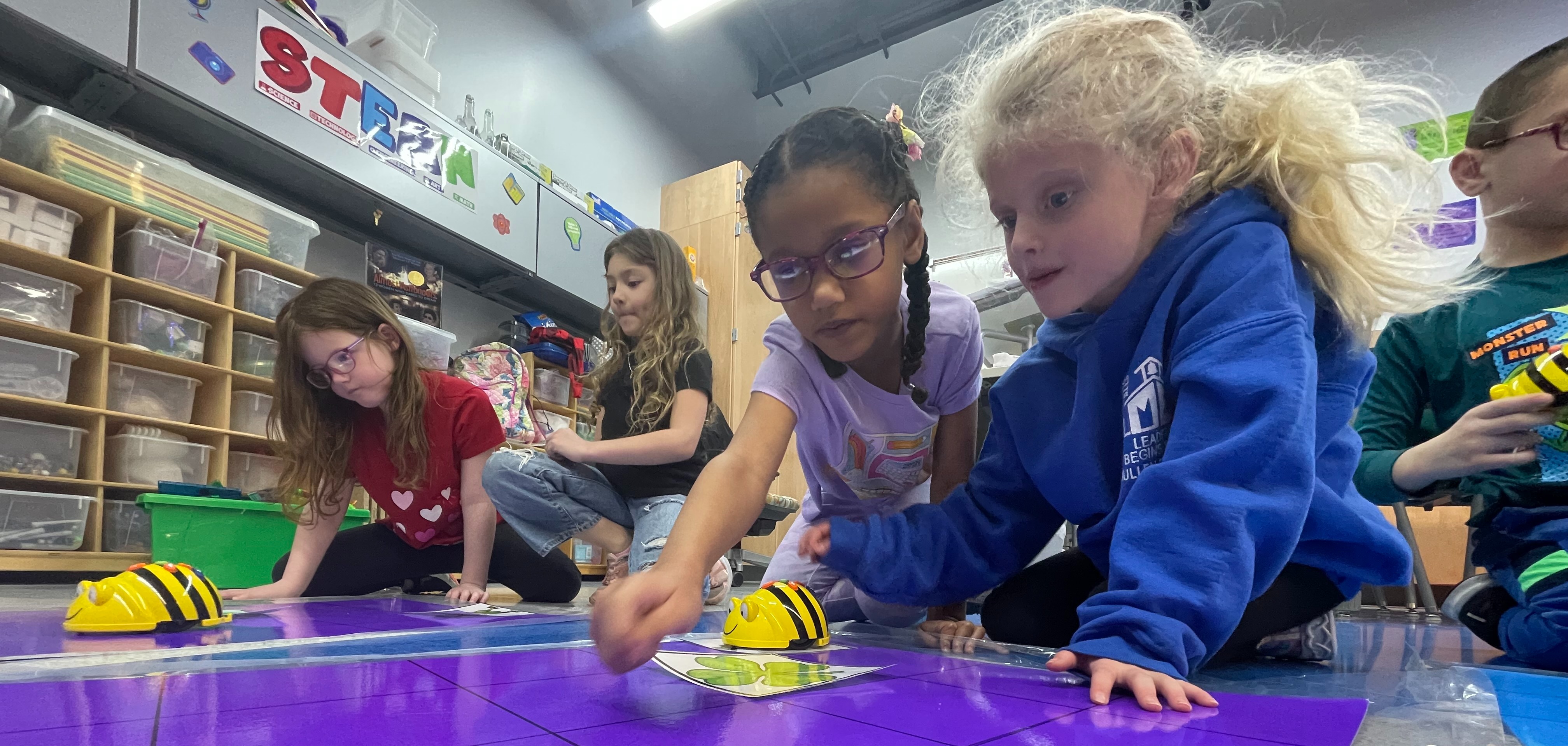 elementary students work with beebots