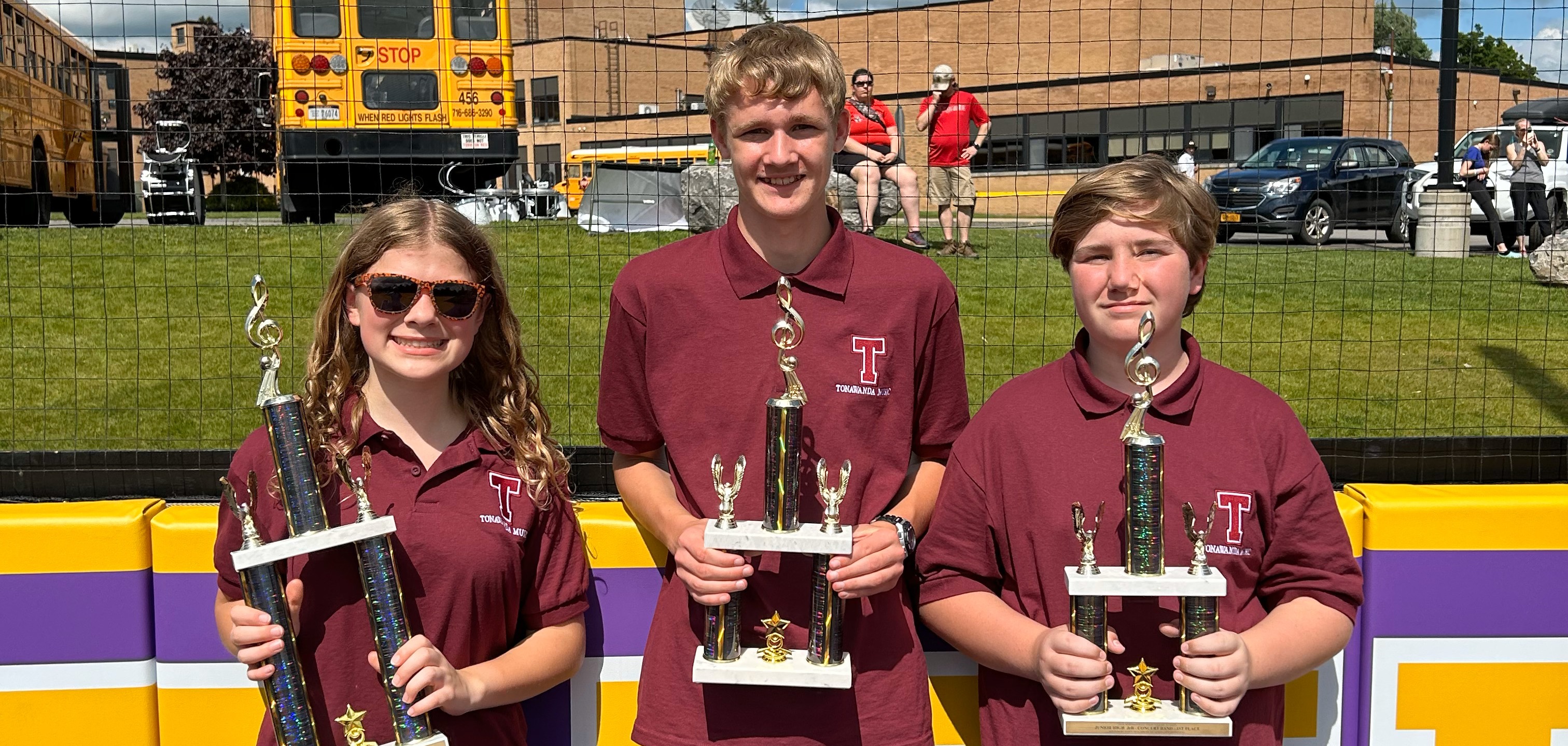students pose with trophies after band competition