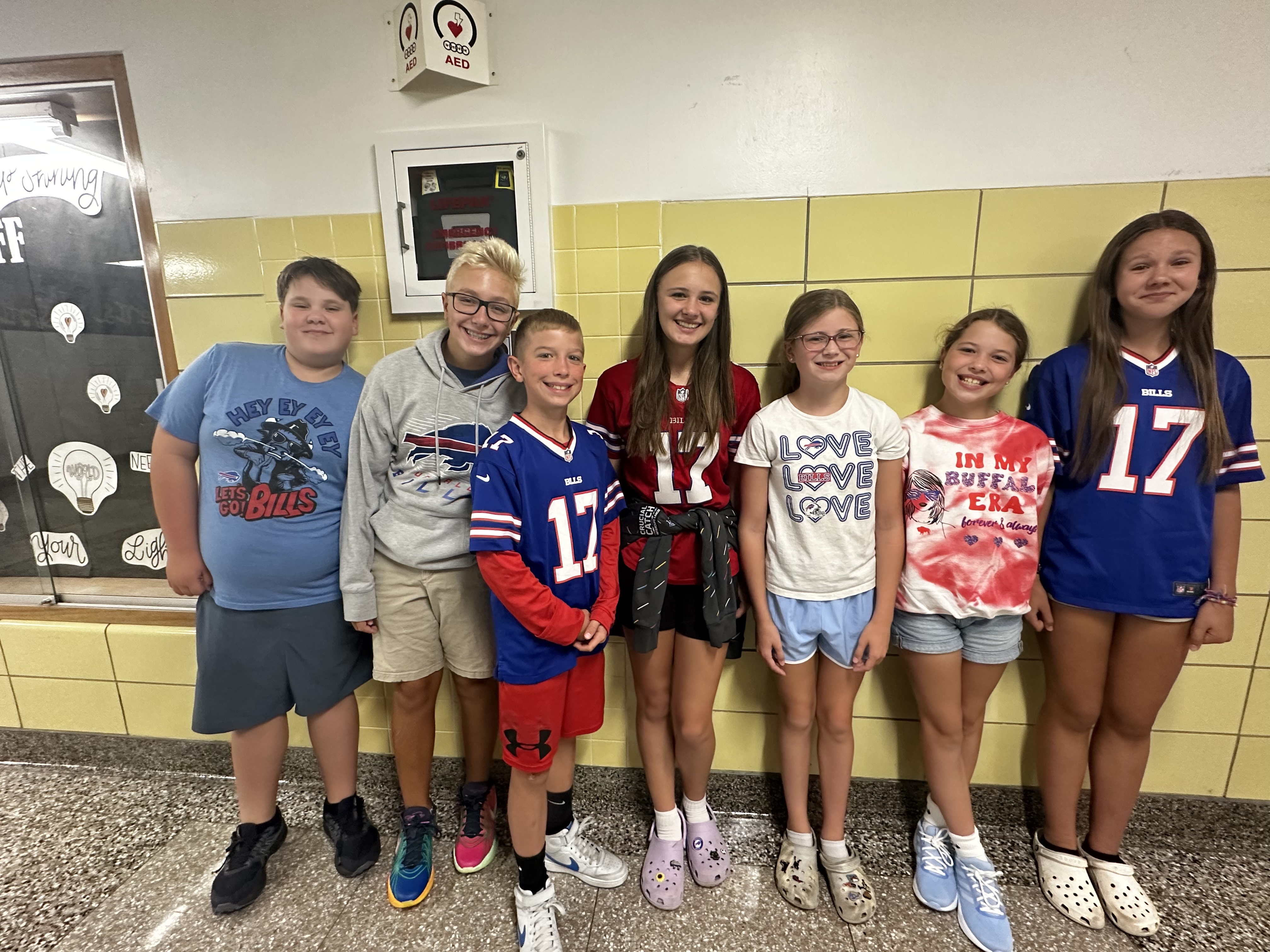 students pose in bills gear