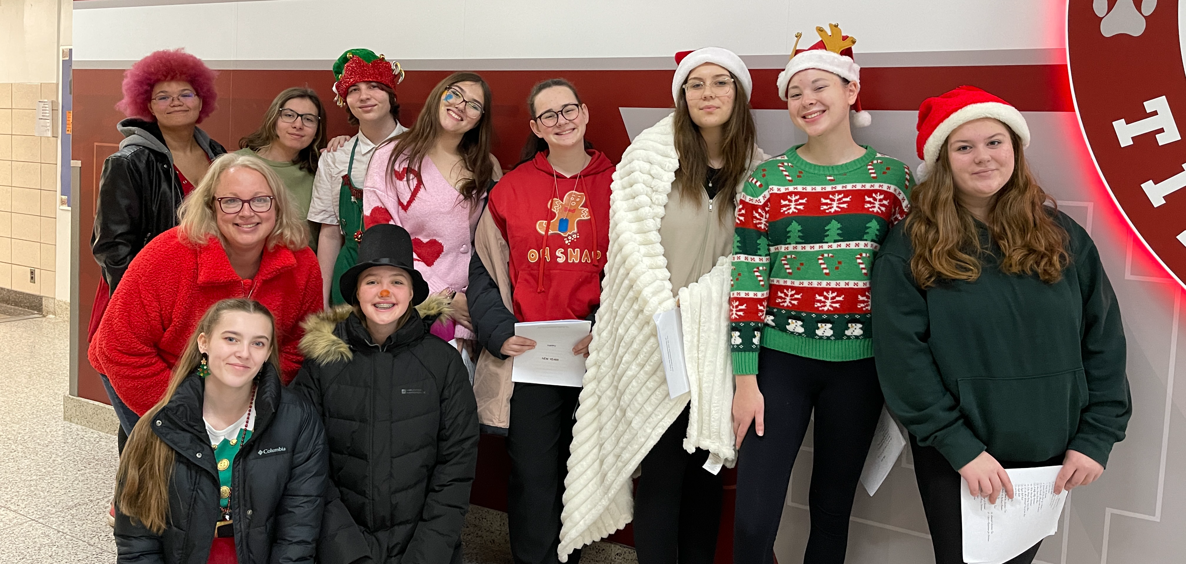 students pose in hallway with holiday outfits