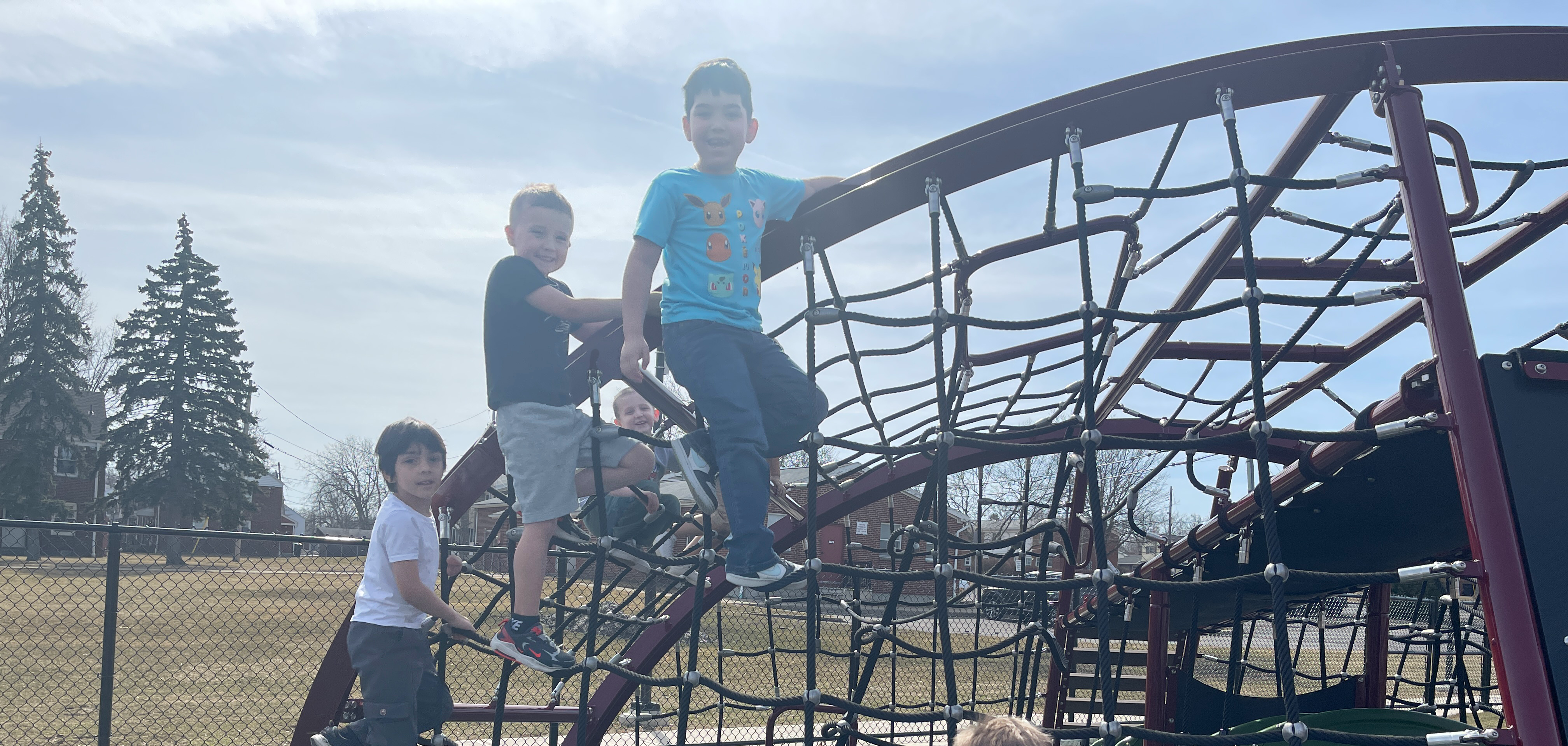 children pose on playground