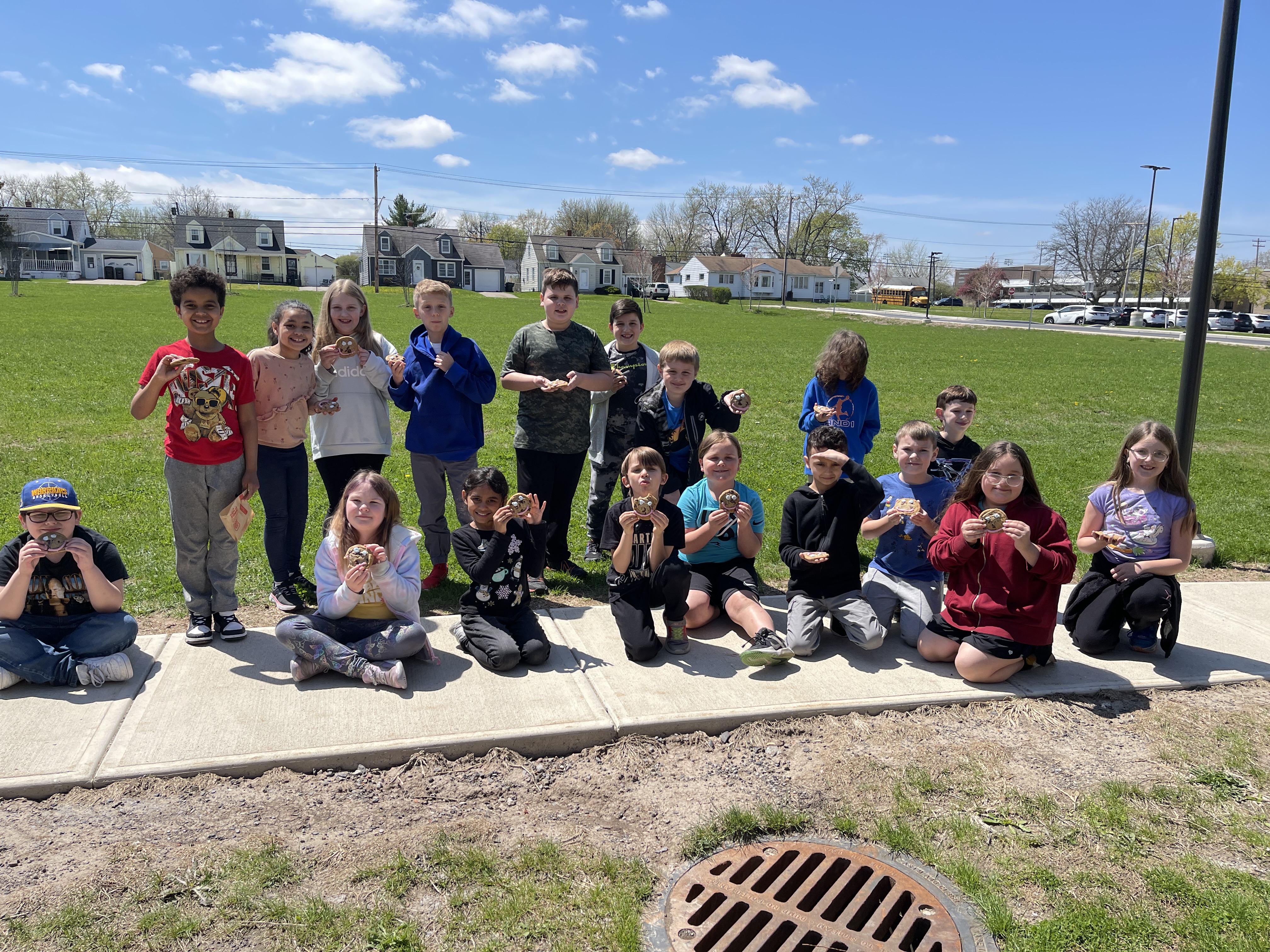 students pose with smile cookies