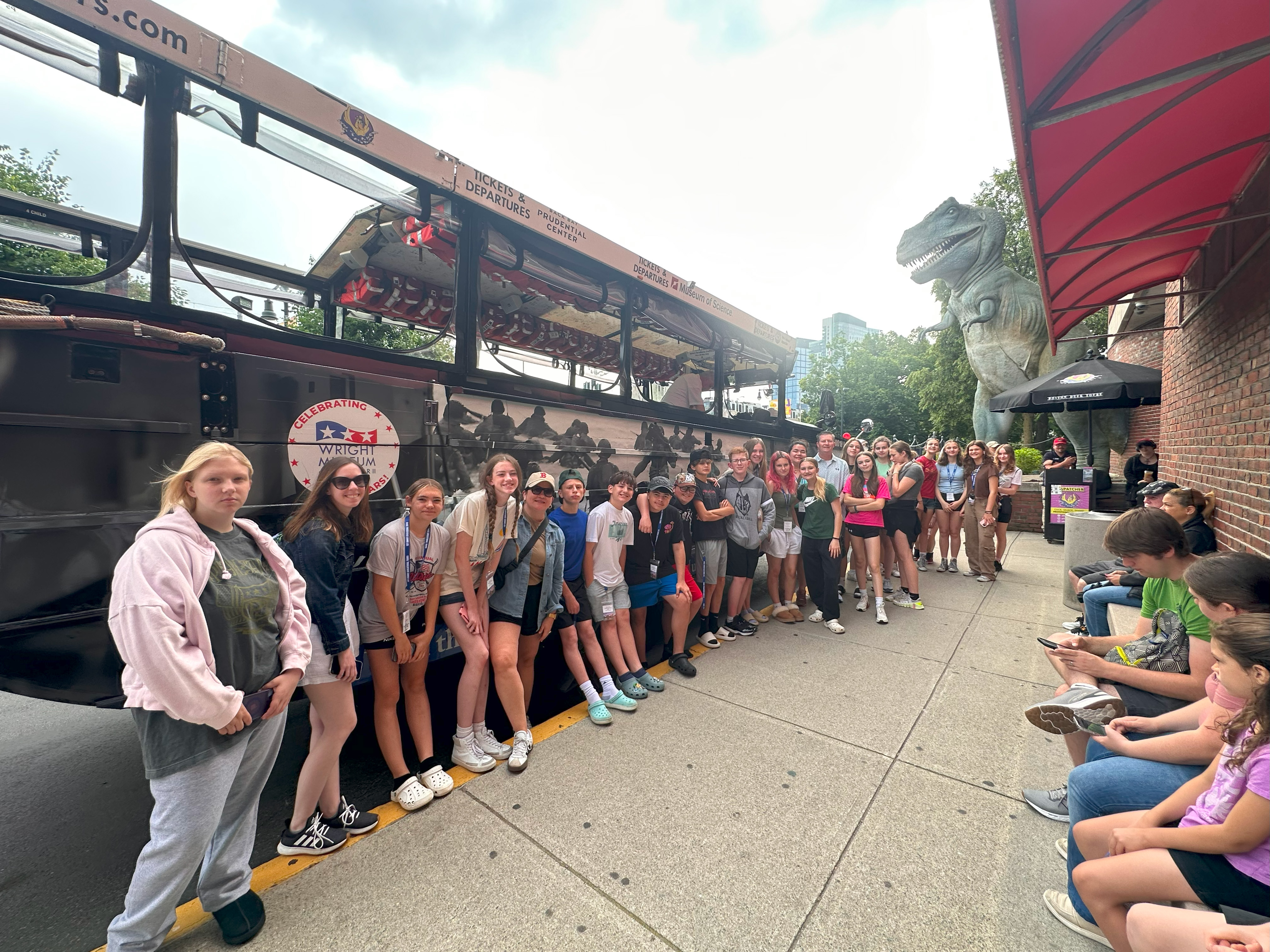 students pose outside bus