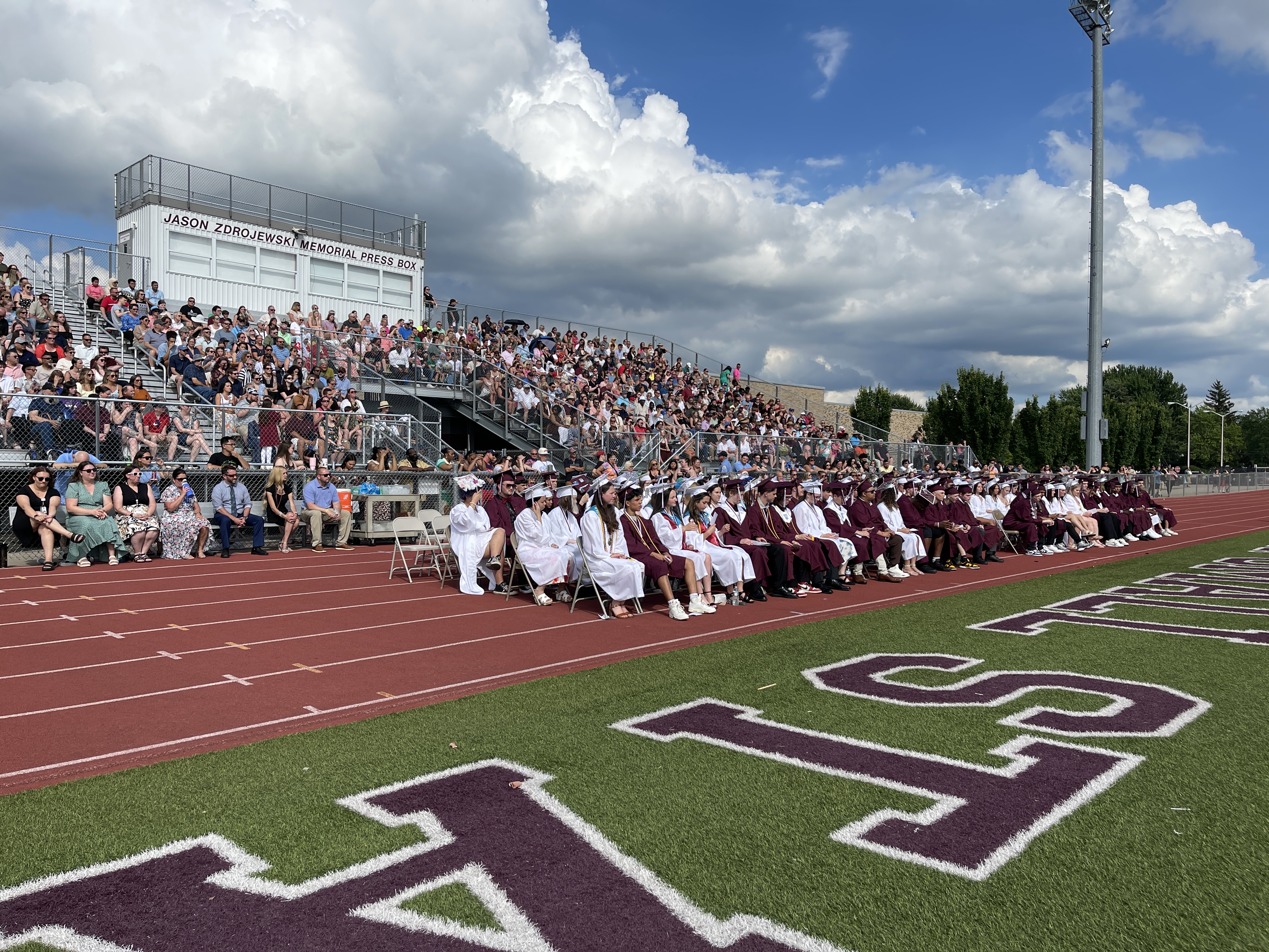 graduation wide shot of students and audience