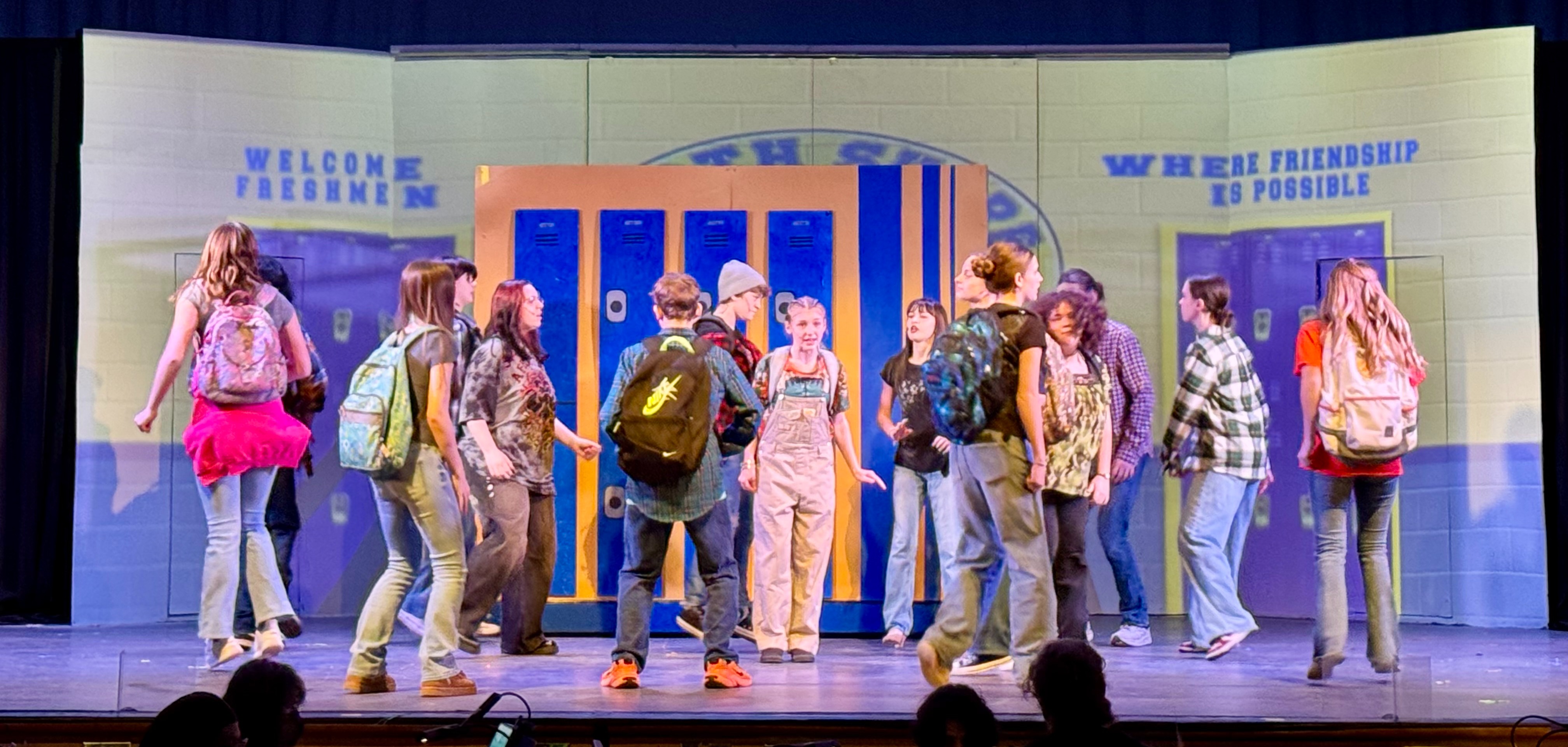 mean girls cast on stage acting out scene