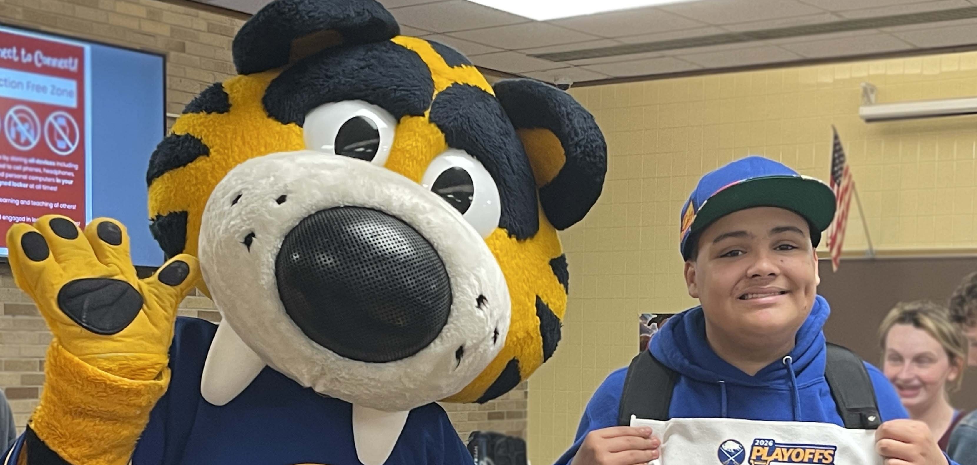 student poses with sabretooth and we're back towel