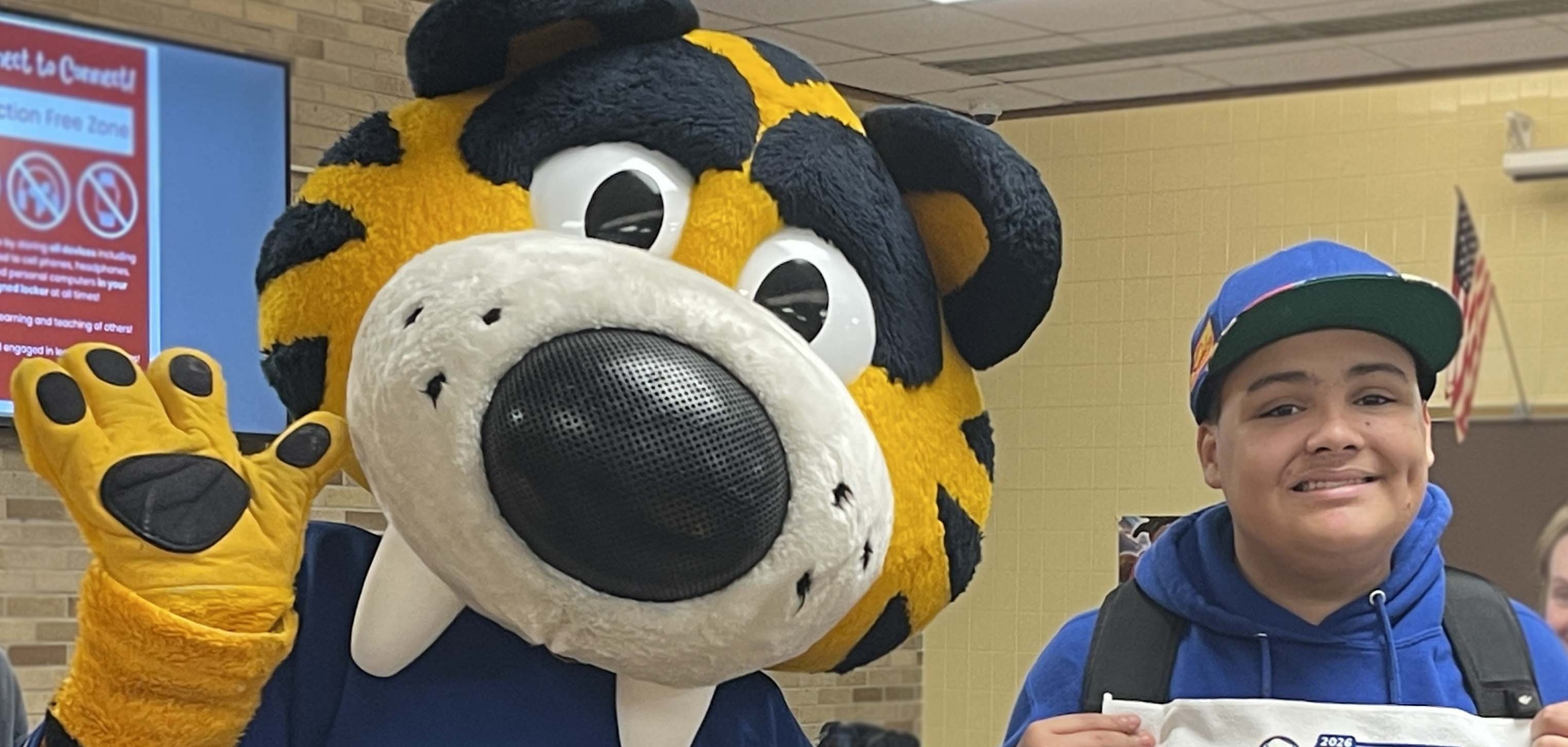student poses with sabretooth and we're back towel