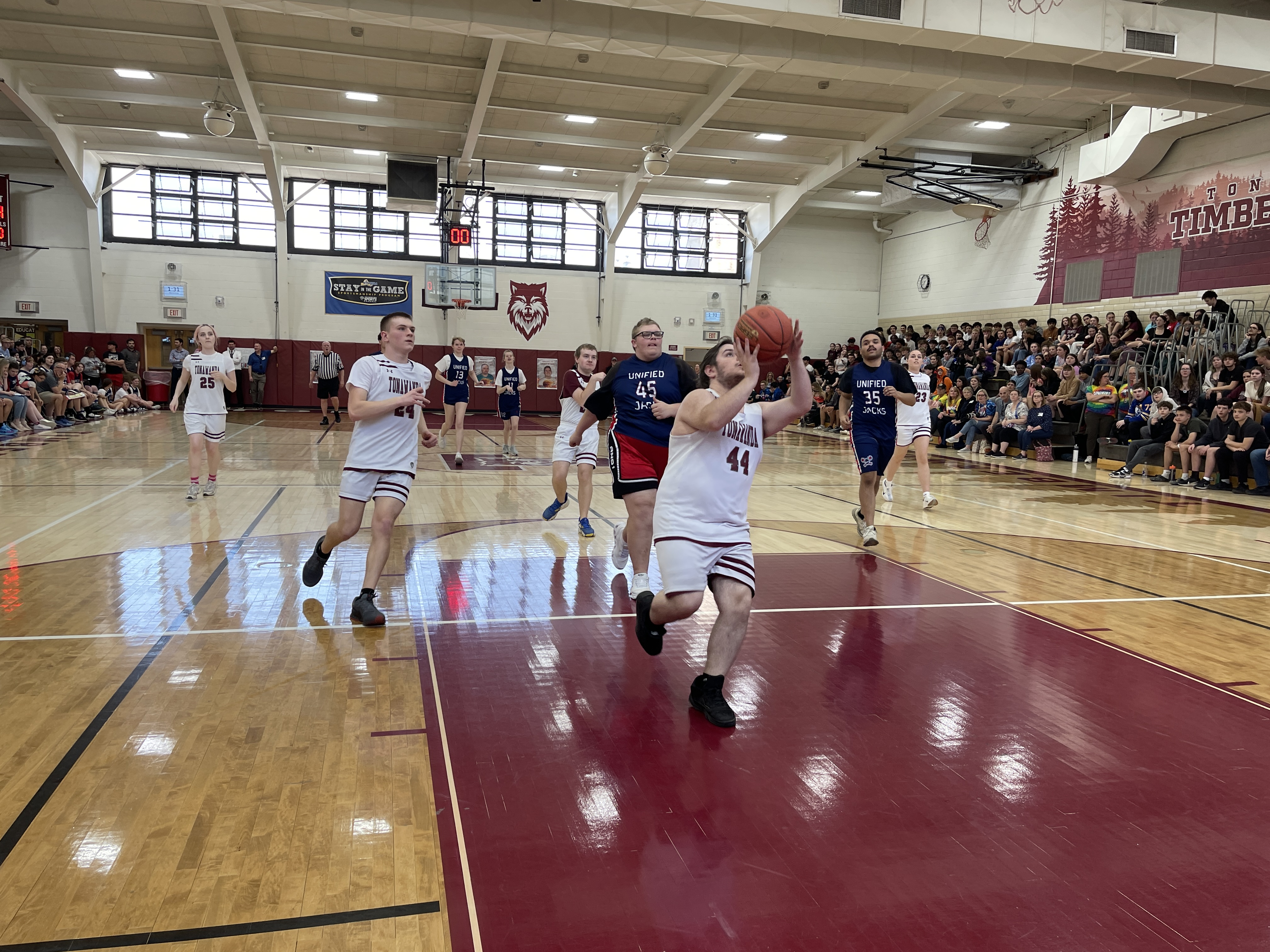students playing on basketball court