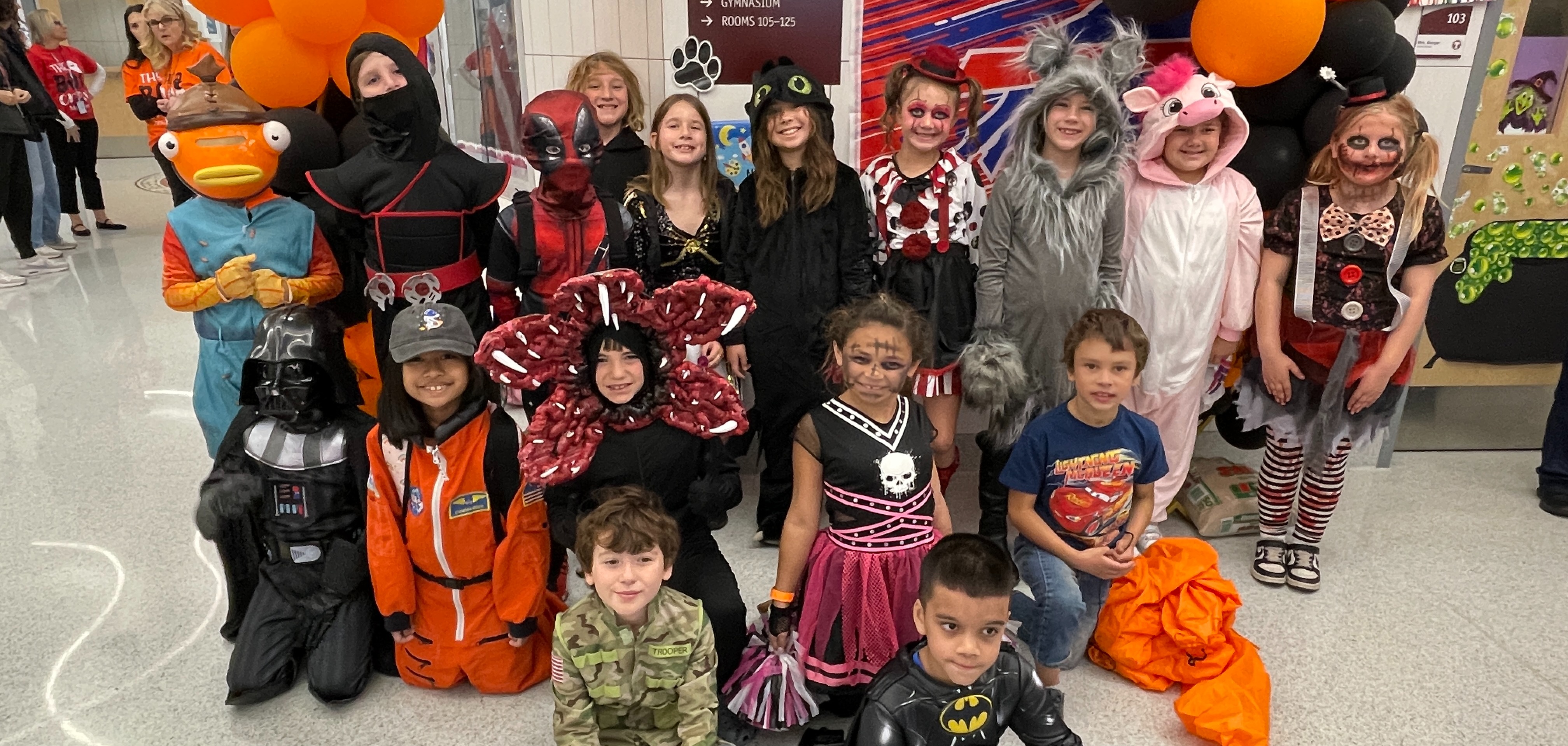 students pose in halloween costumes