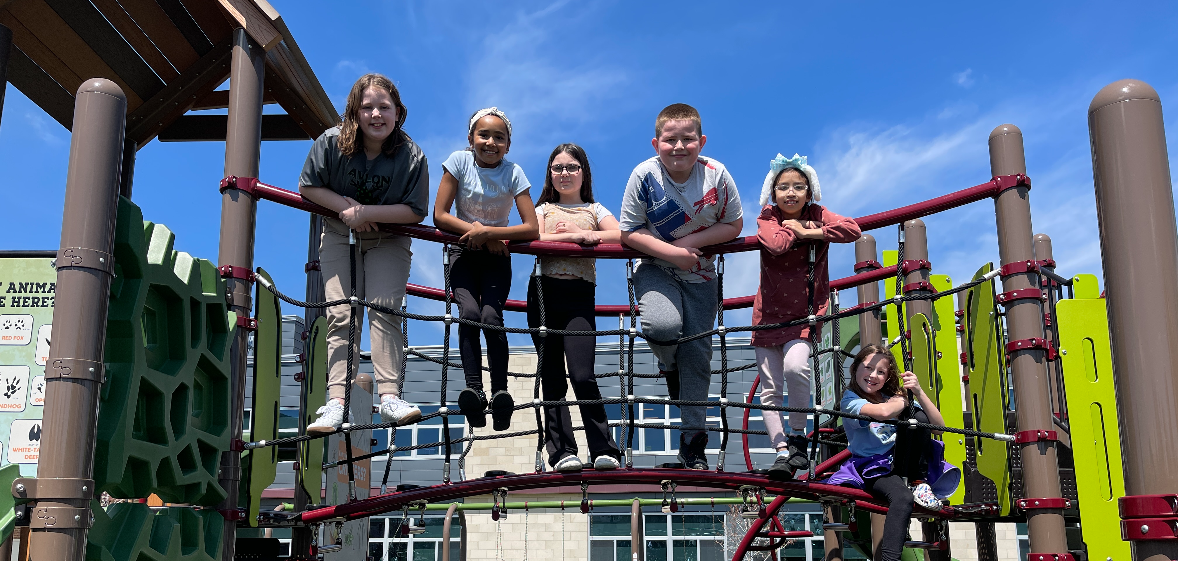 students pose on playground