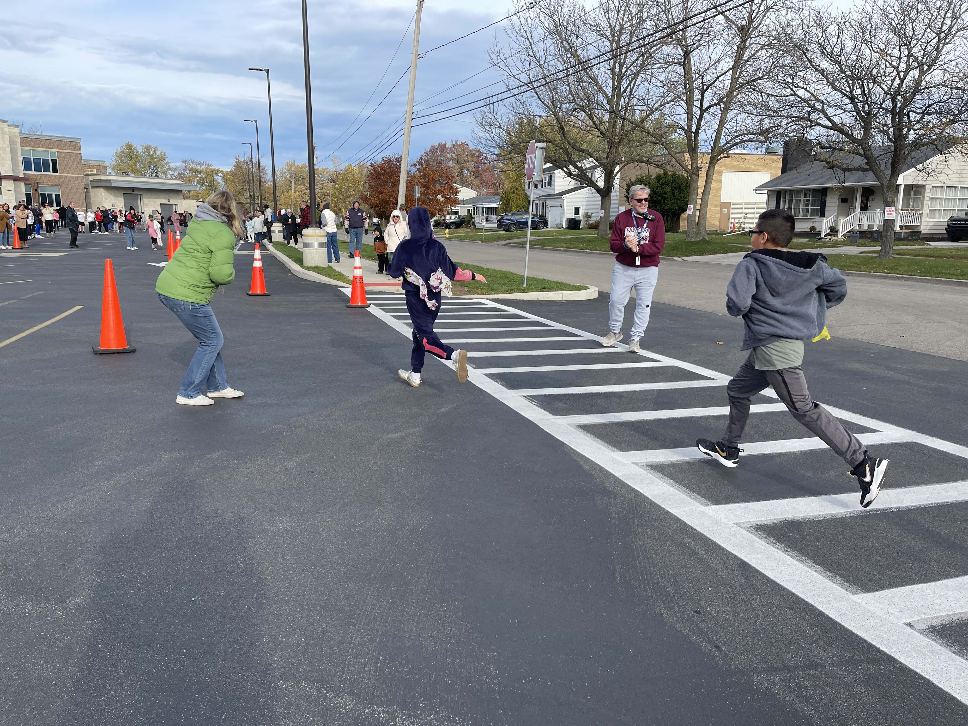 dog gets high five when finishing turkey trot