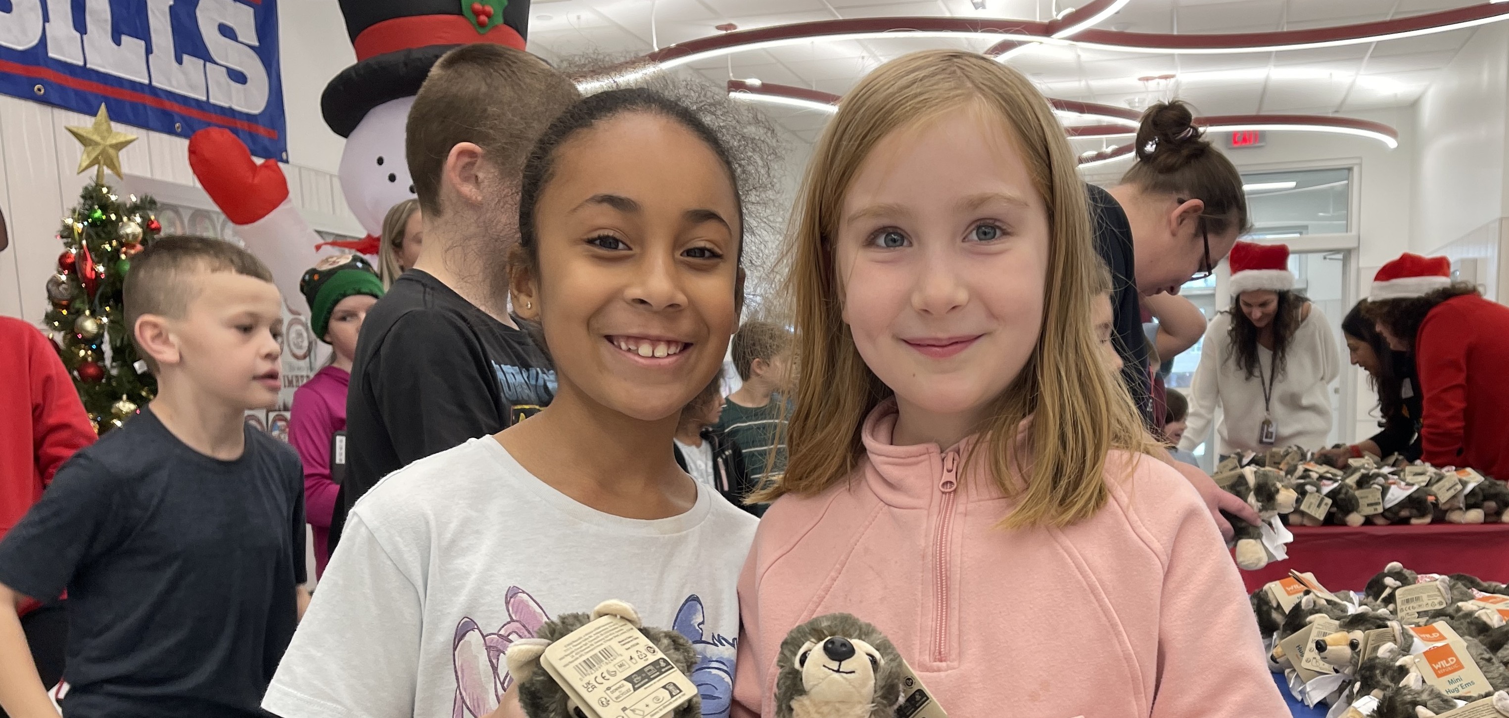 two girls pose with their birthday stuffed animals