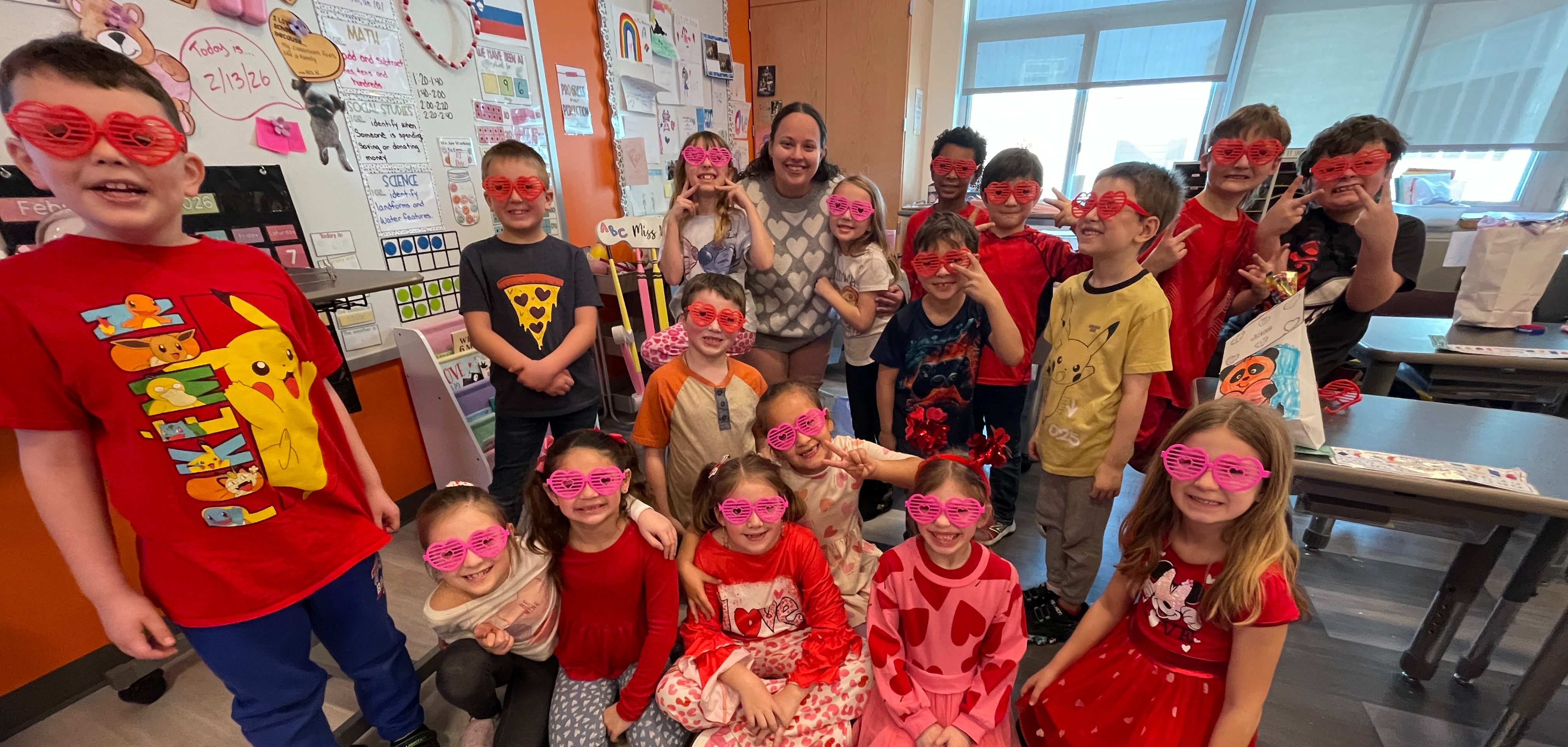 students pose in heart glasses