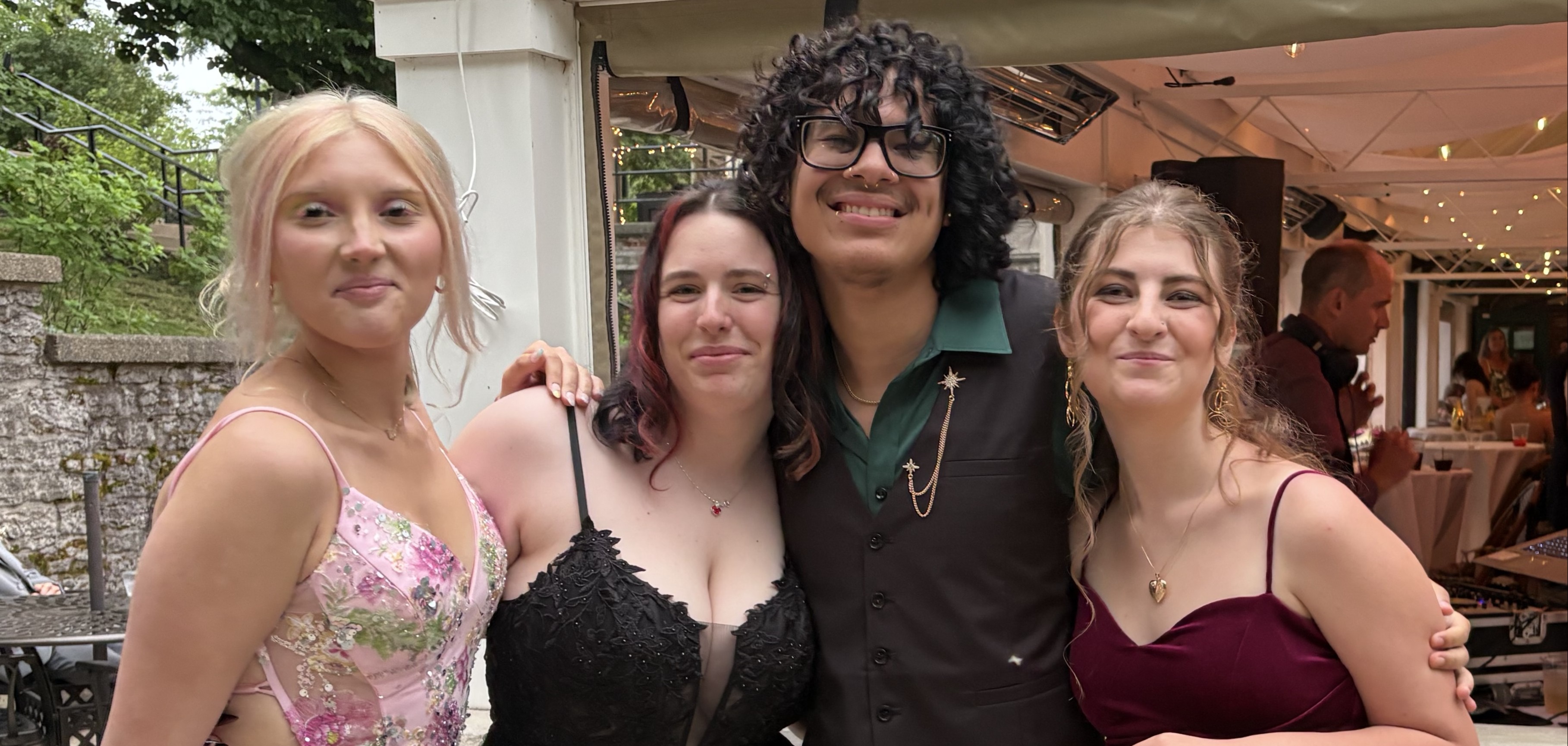 students pose in prom dresses