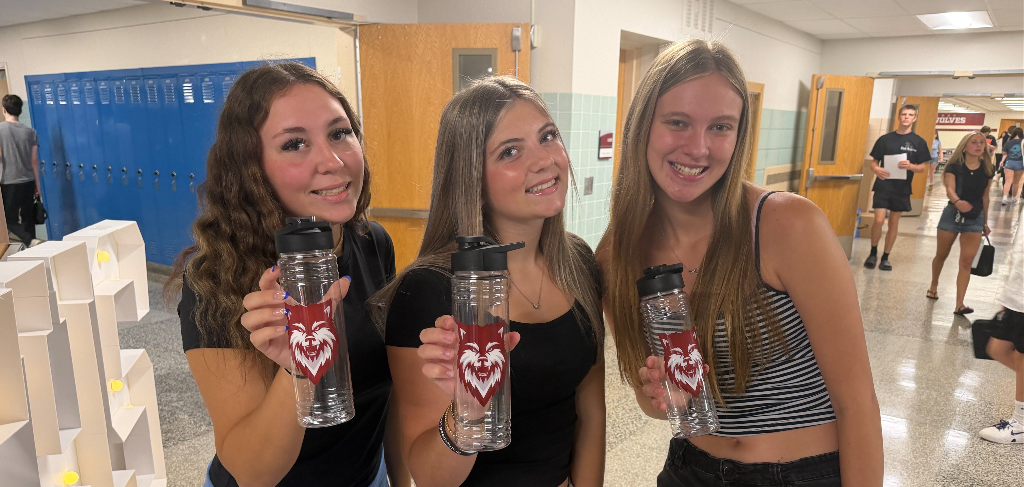 students show off new waterbottles