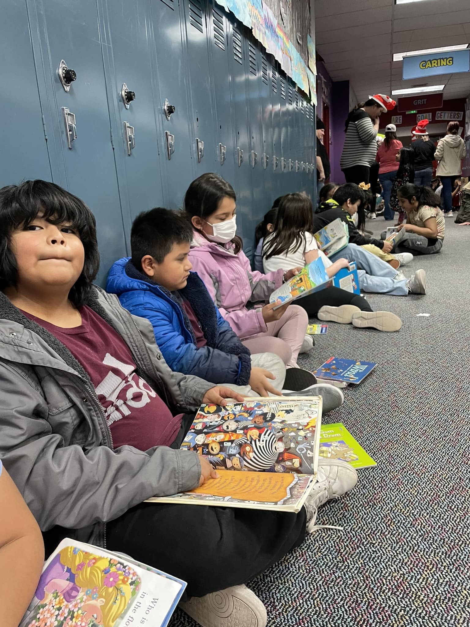 Morris Schott Students read in the hallway on Read Across America Day