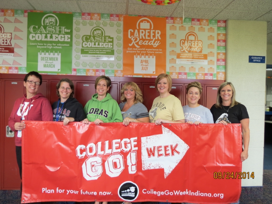 Faculty holding a College Go! Week sign