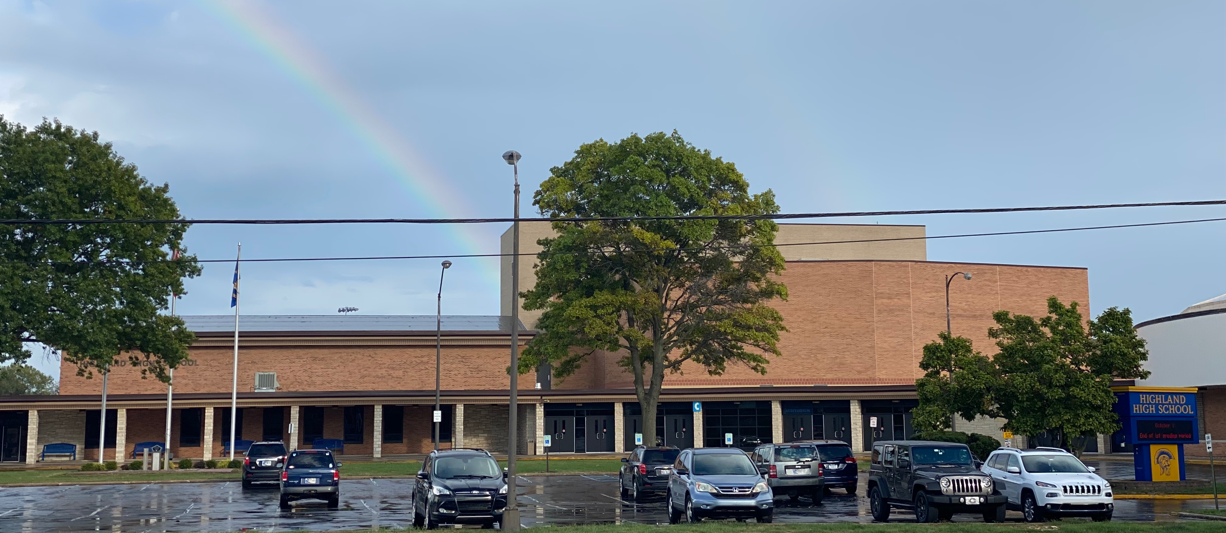 Photo of school with rainbow above it