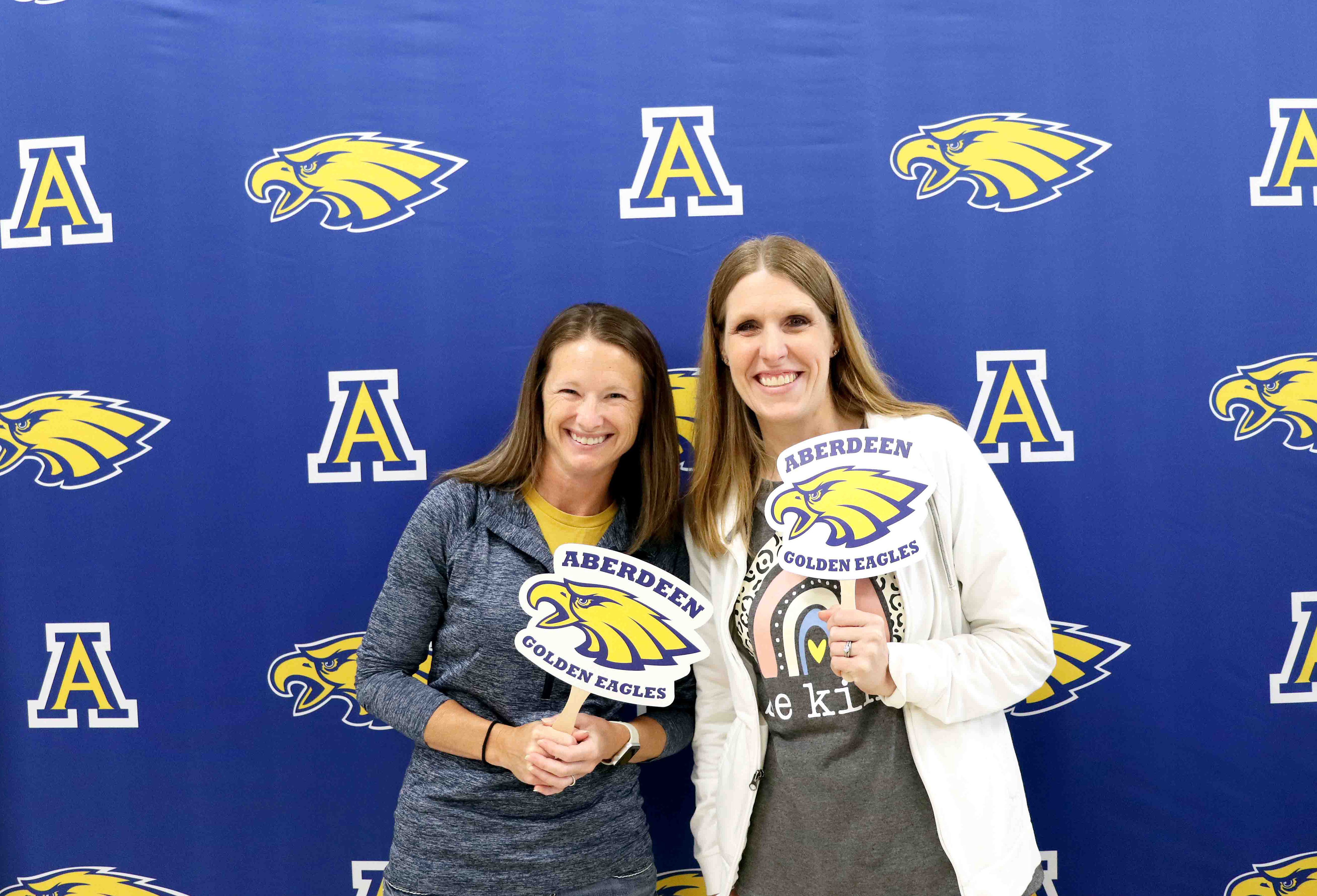 Teachers in front of an Aberdeen School District backdrop