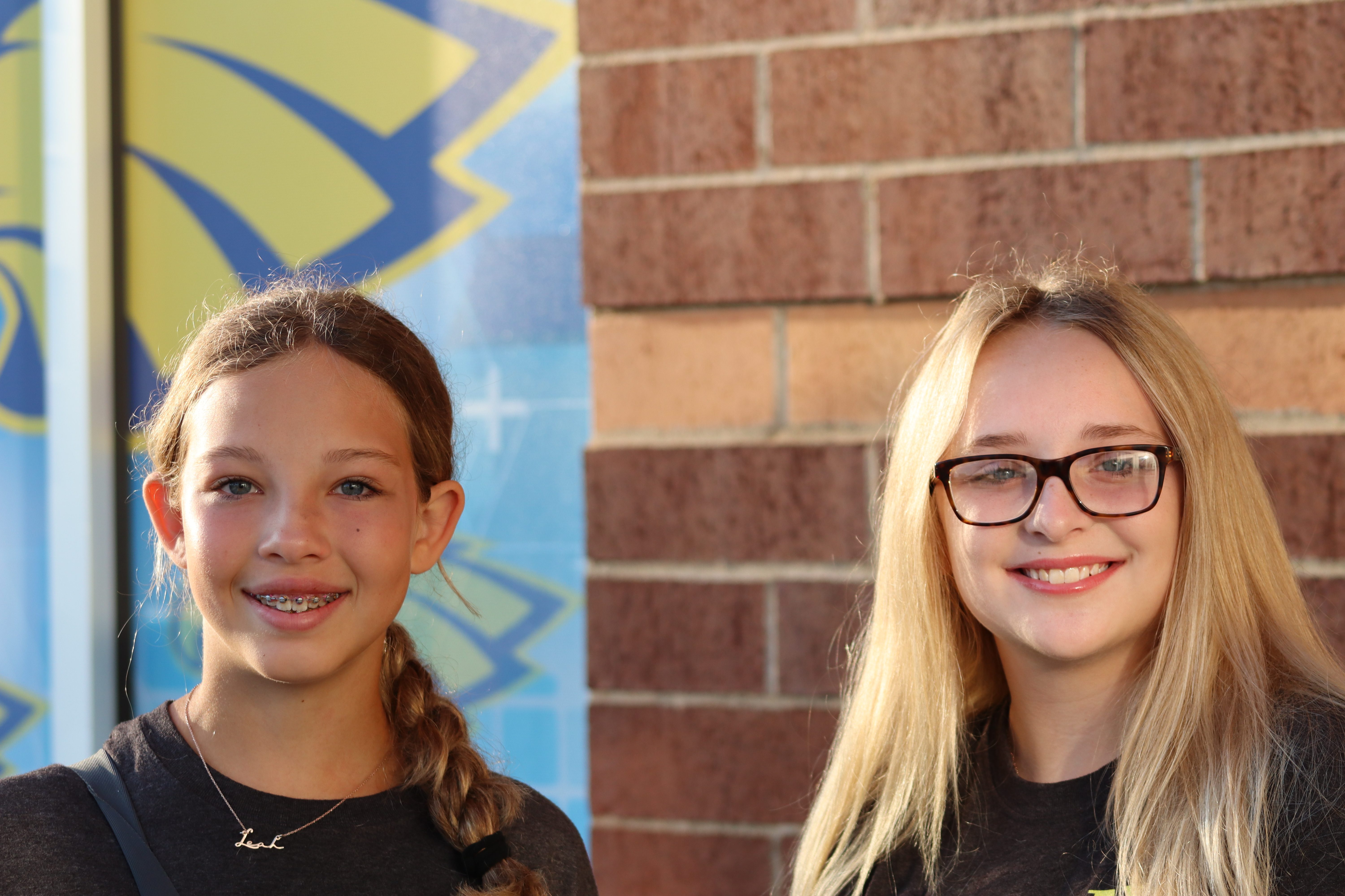 Two students stand outside Simmons Middle School