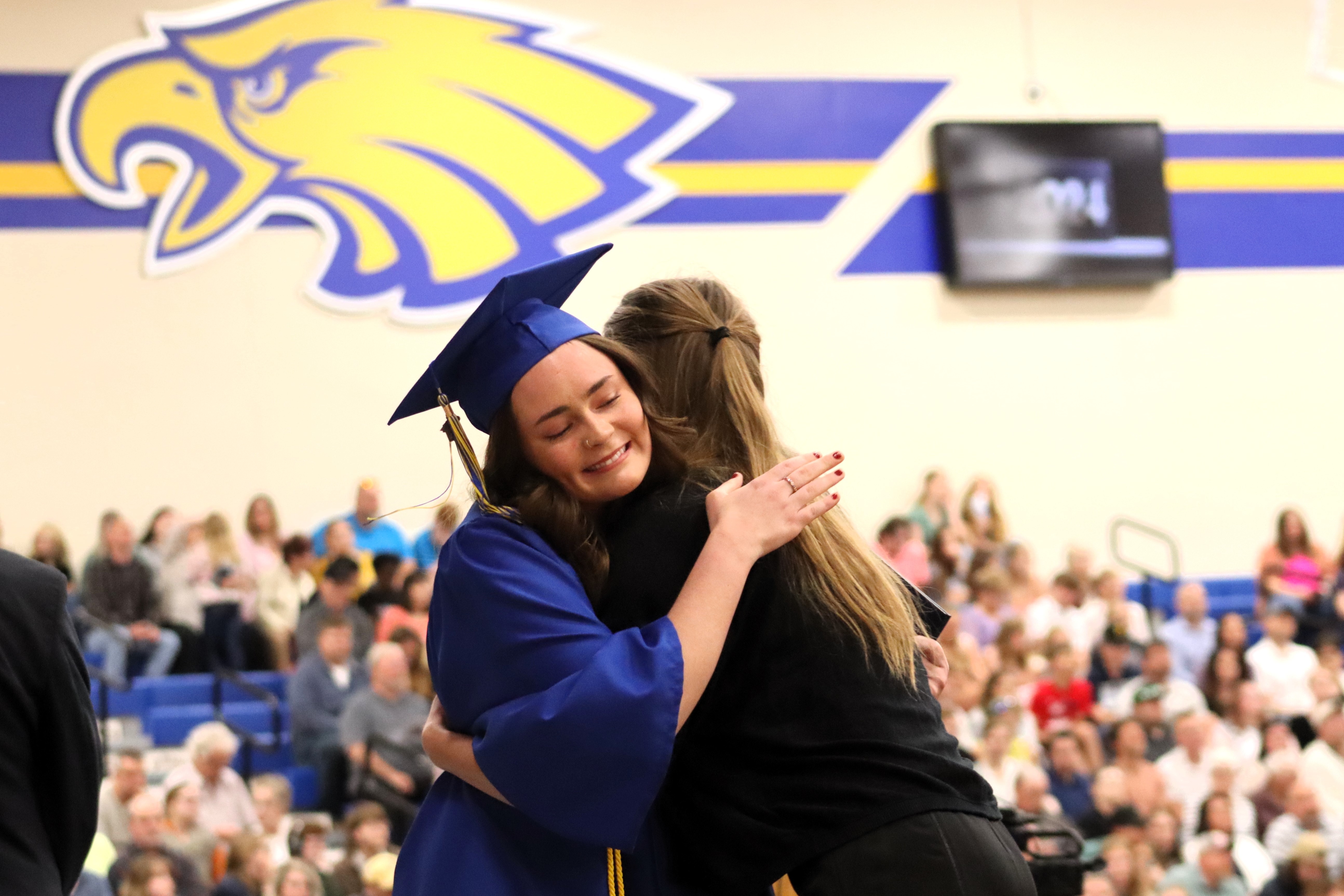 Graduate hugging a staff member