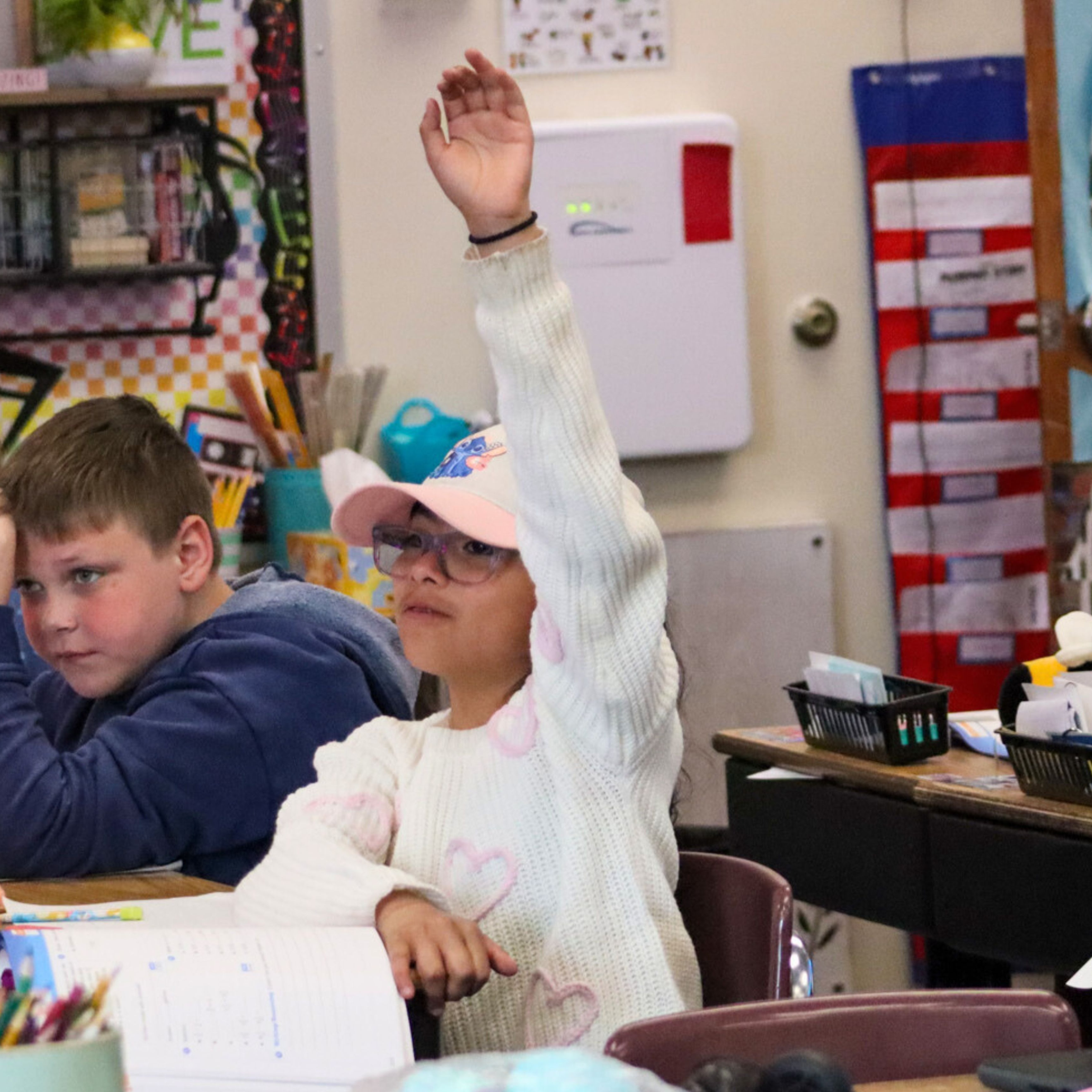 Student raising her hand in class