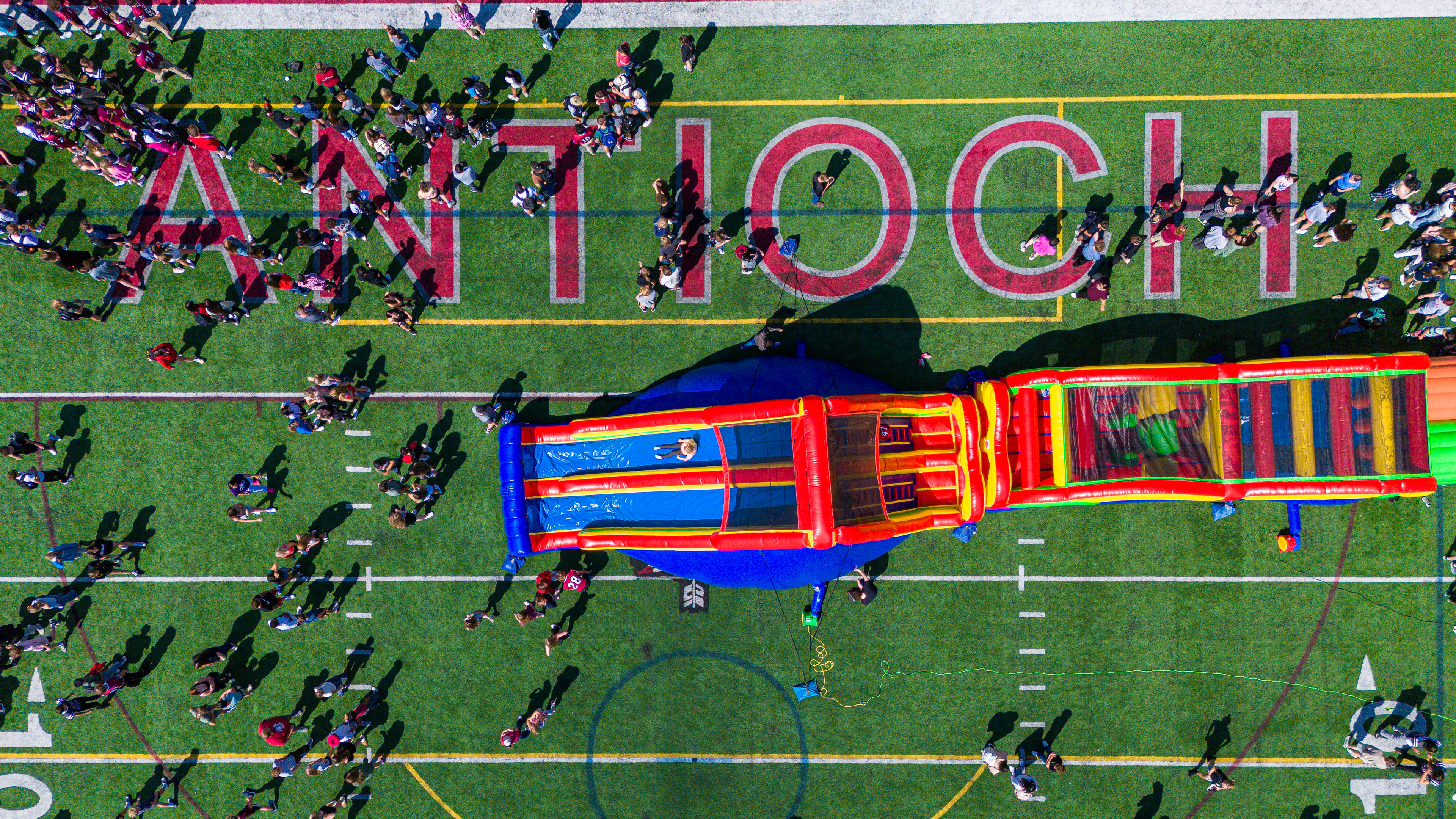 Birds eye view of bouncy house at back to school bash on the football field.