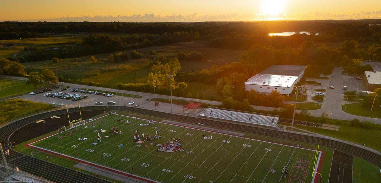 aerial view of our football field with students at sunrise