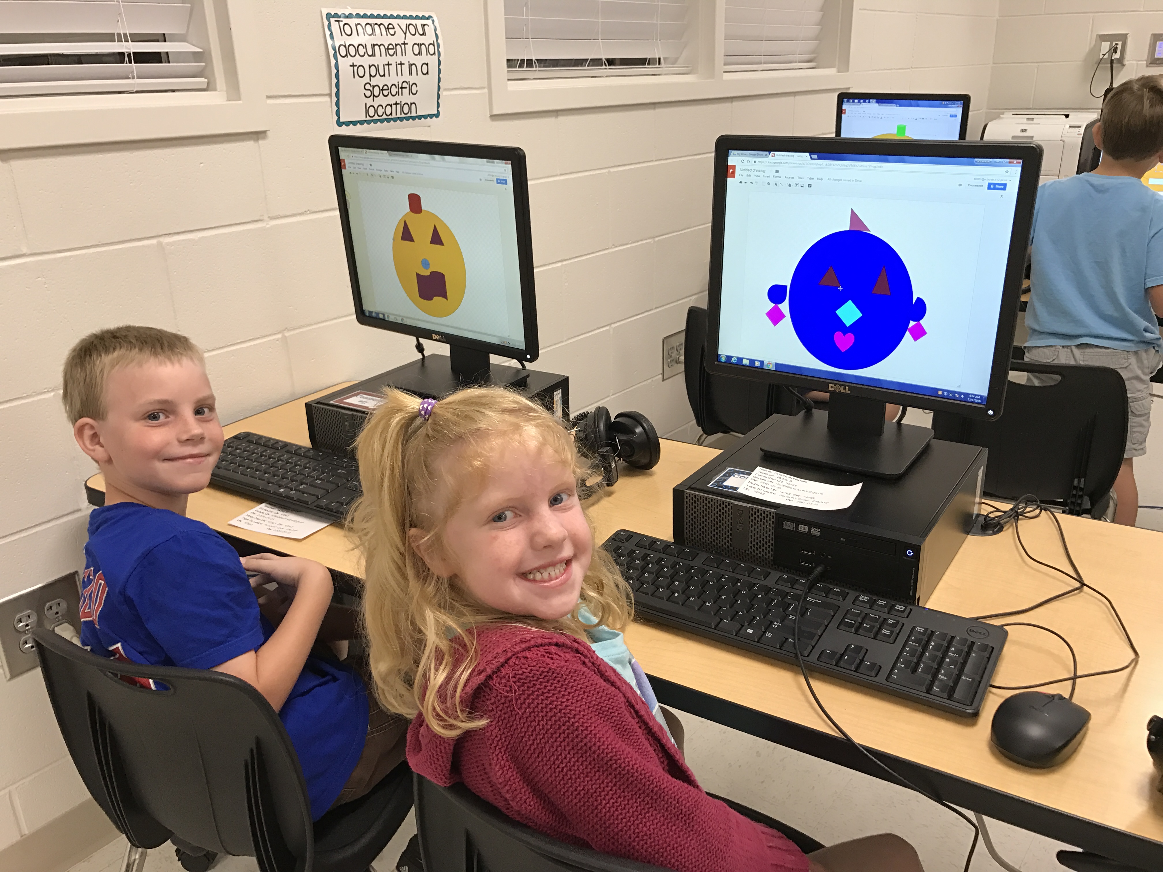 2 students in front of a desktop computer