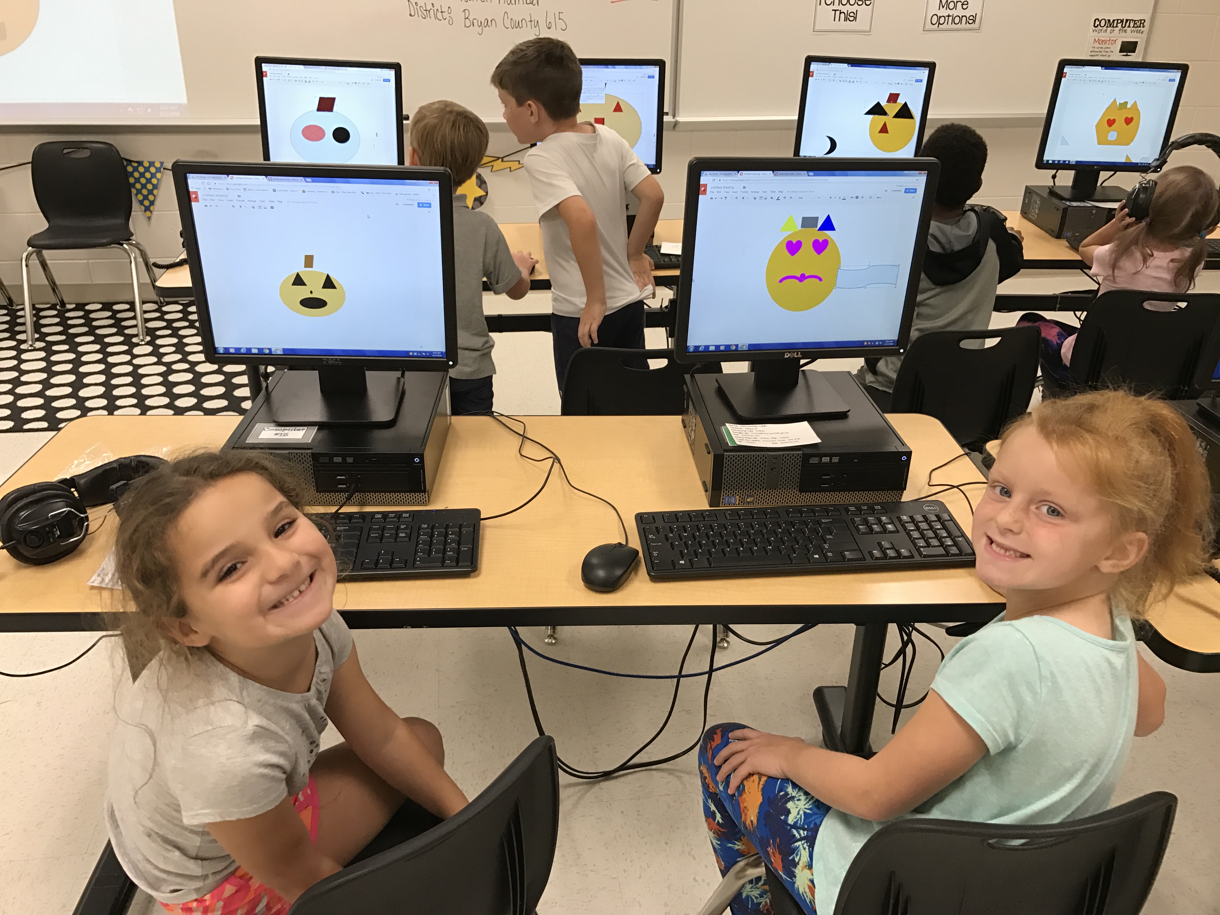 2 female students smiling in computer lab