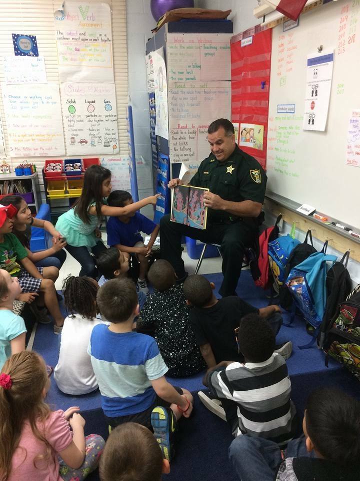officer reading to students