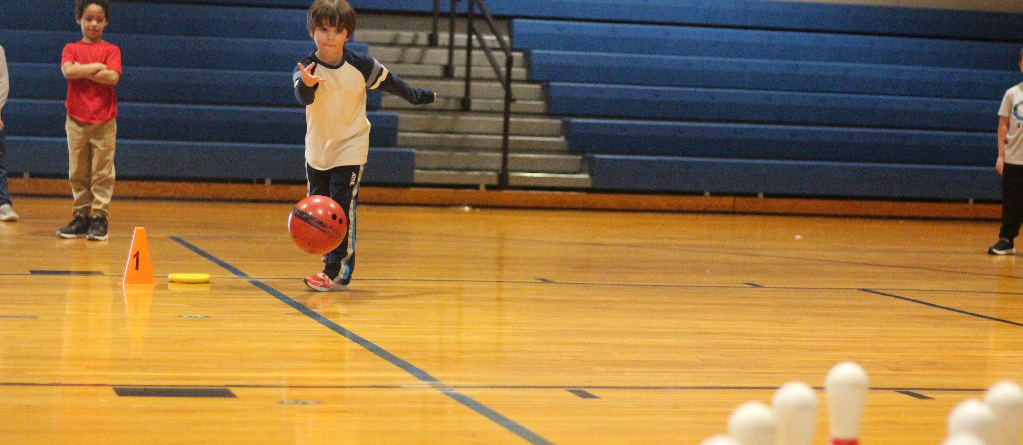 student bowling in PE class
