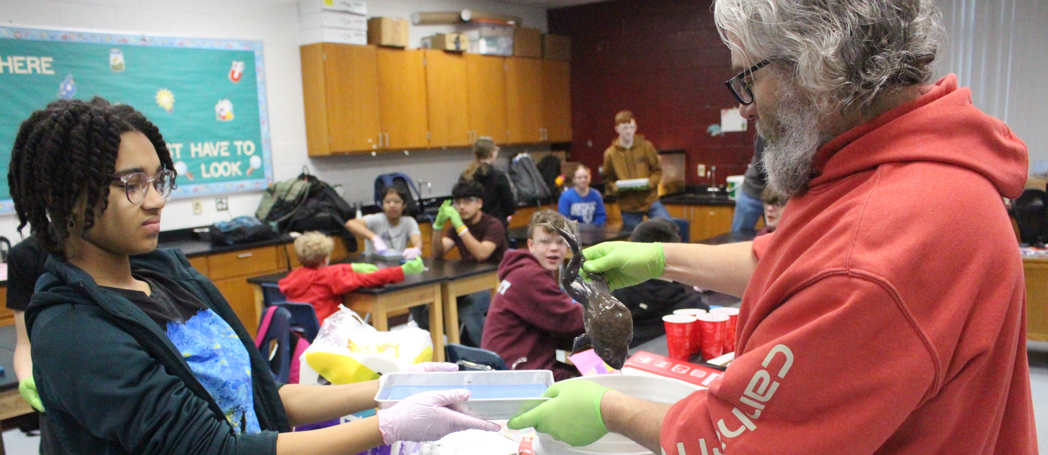 students and teacher during science class
