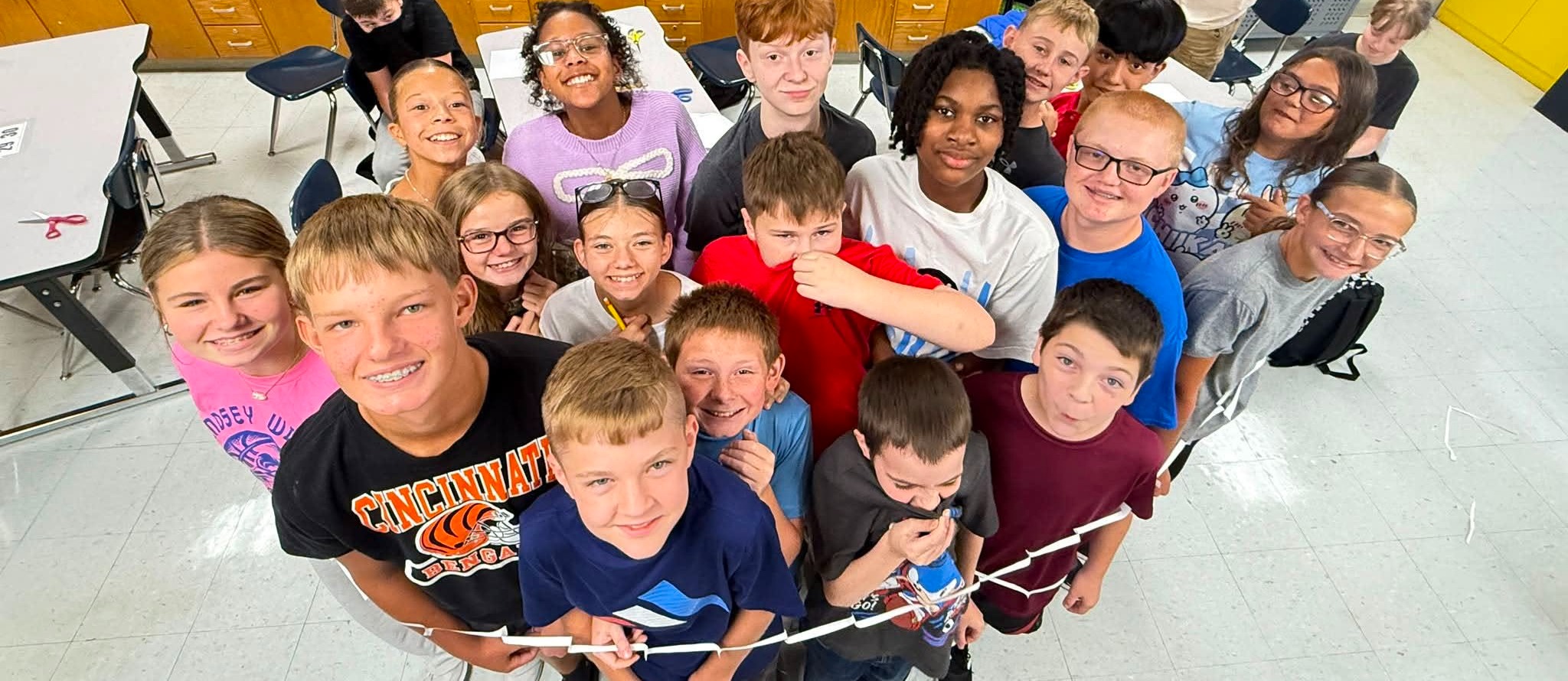 students standing in paper ring