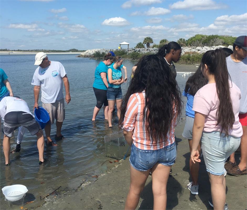 Group of students digging in water