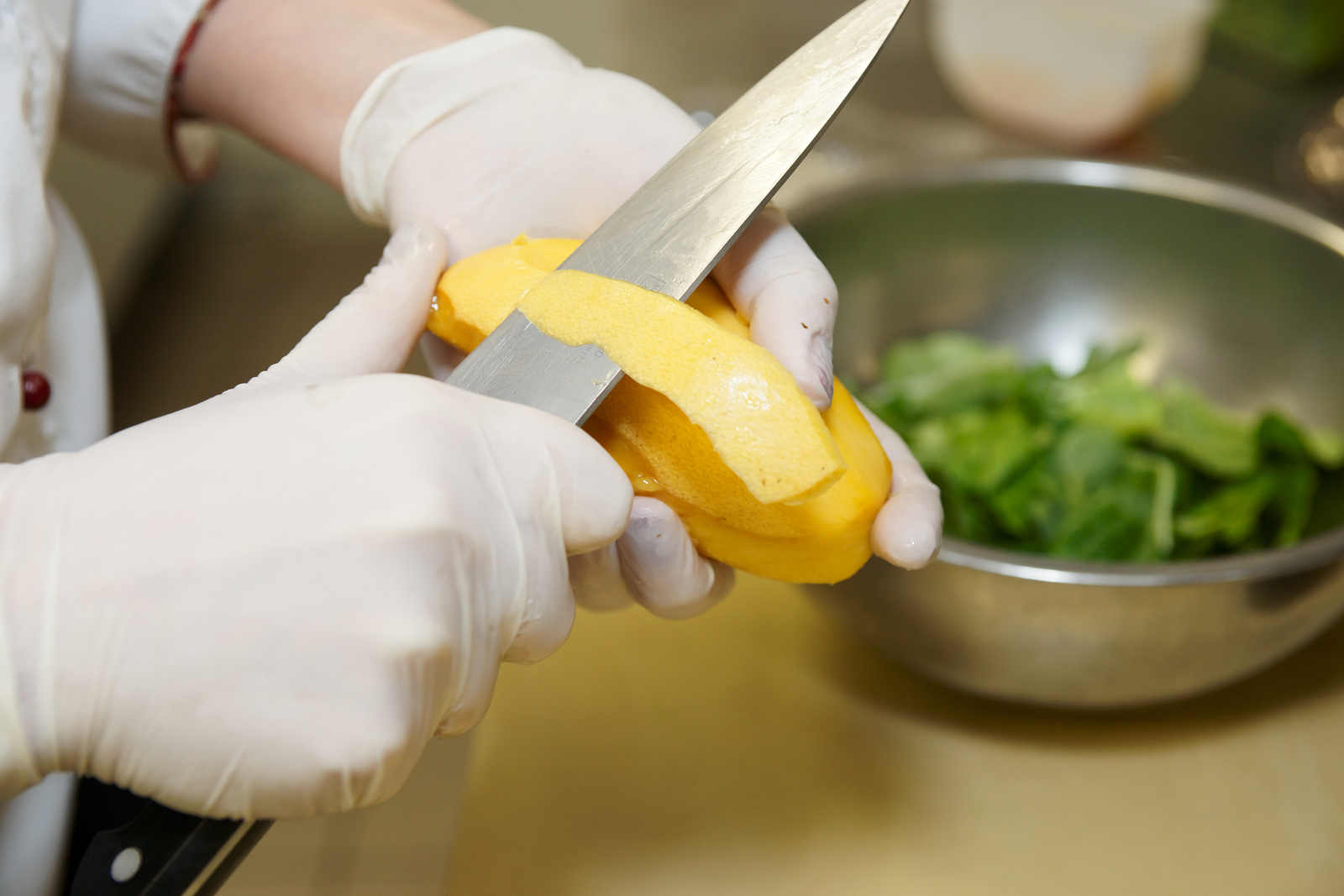 Stock photo of a chef peeling a vegetable