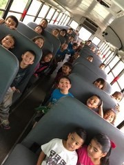 photo of students on a school bus