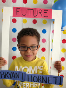 Little Boy holding "Future Bryant Hornet" frame