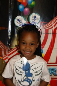 Little girl holding paper hornet cutout